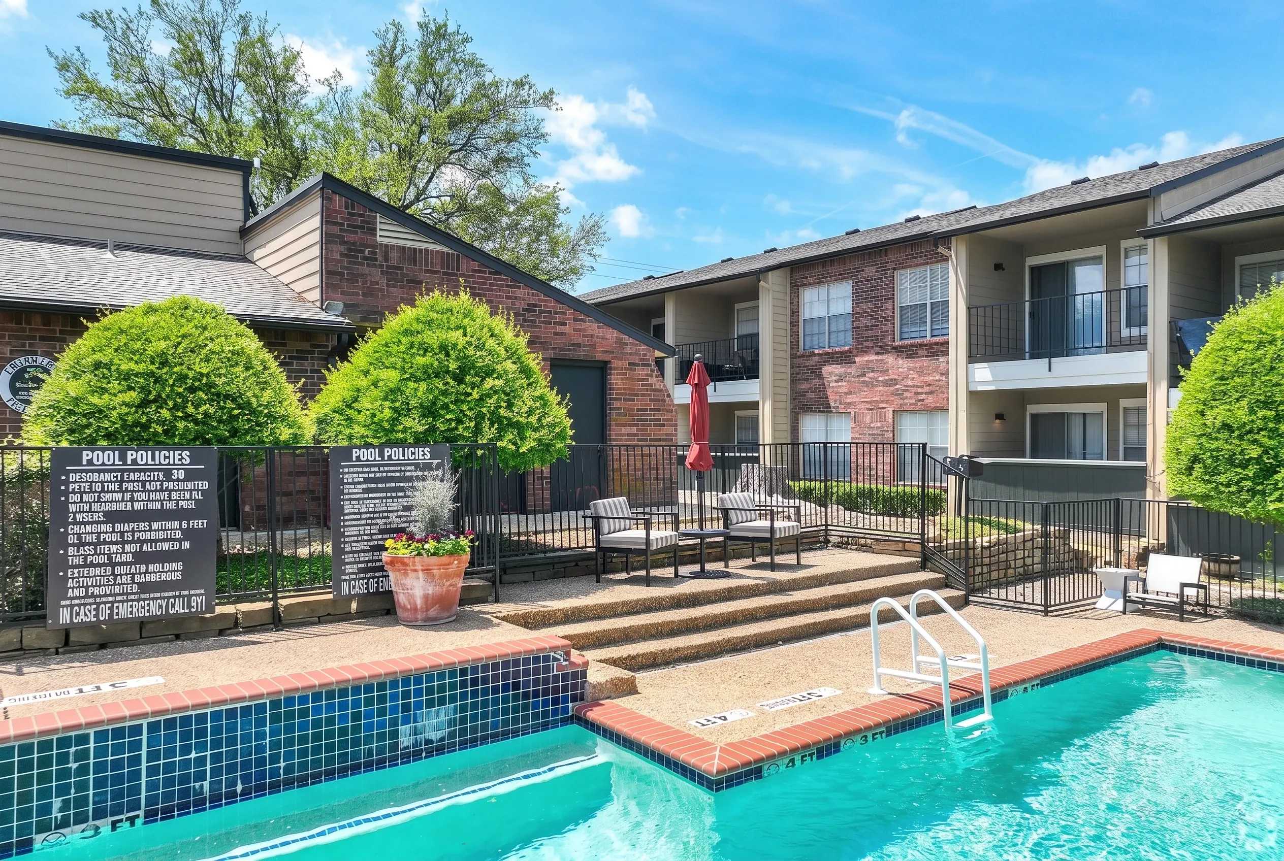 Swimming pool with turquoise water, brick decking, lounge seating, multi-story apartment building