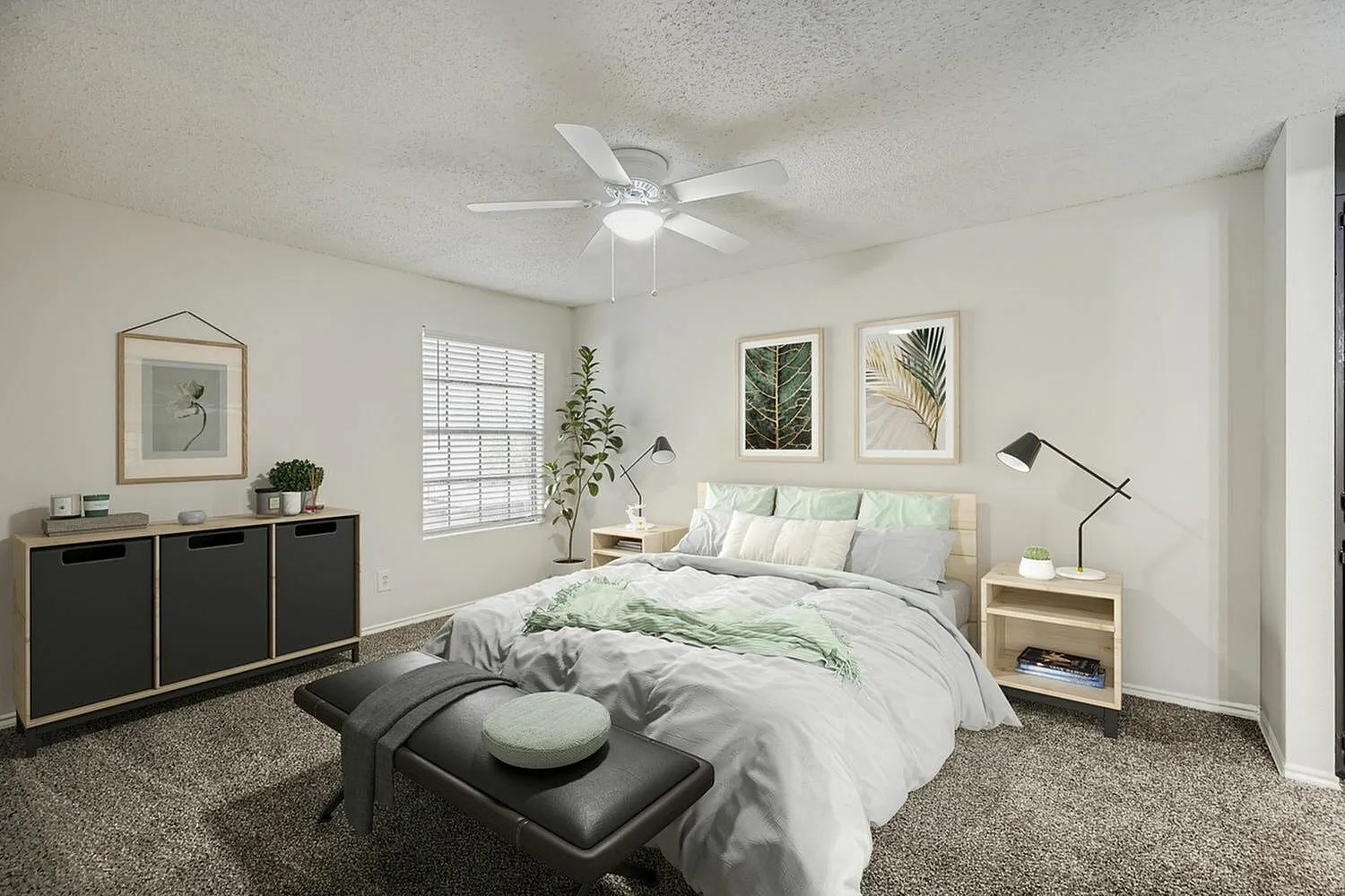 Primary bedroom, wood-style plank flooring, ceiling fan, framed botanical wall art