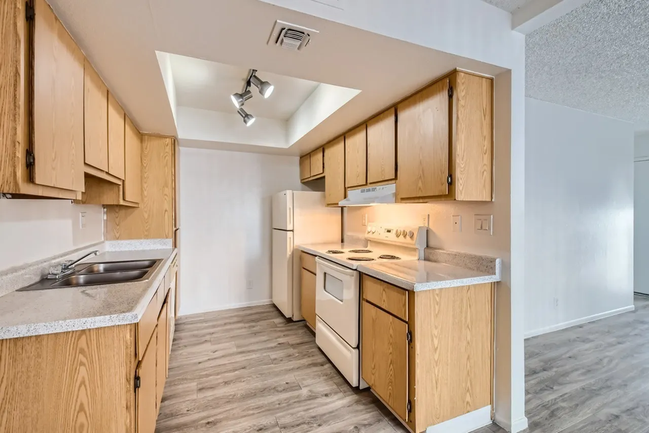 Kitchen, wood shaker cabinetry, quartz countertops, stainless appliances, wood-style plank flooring