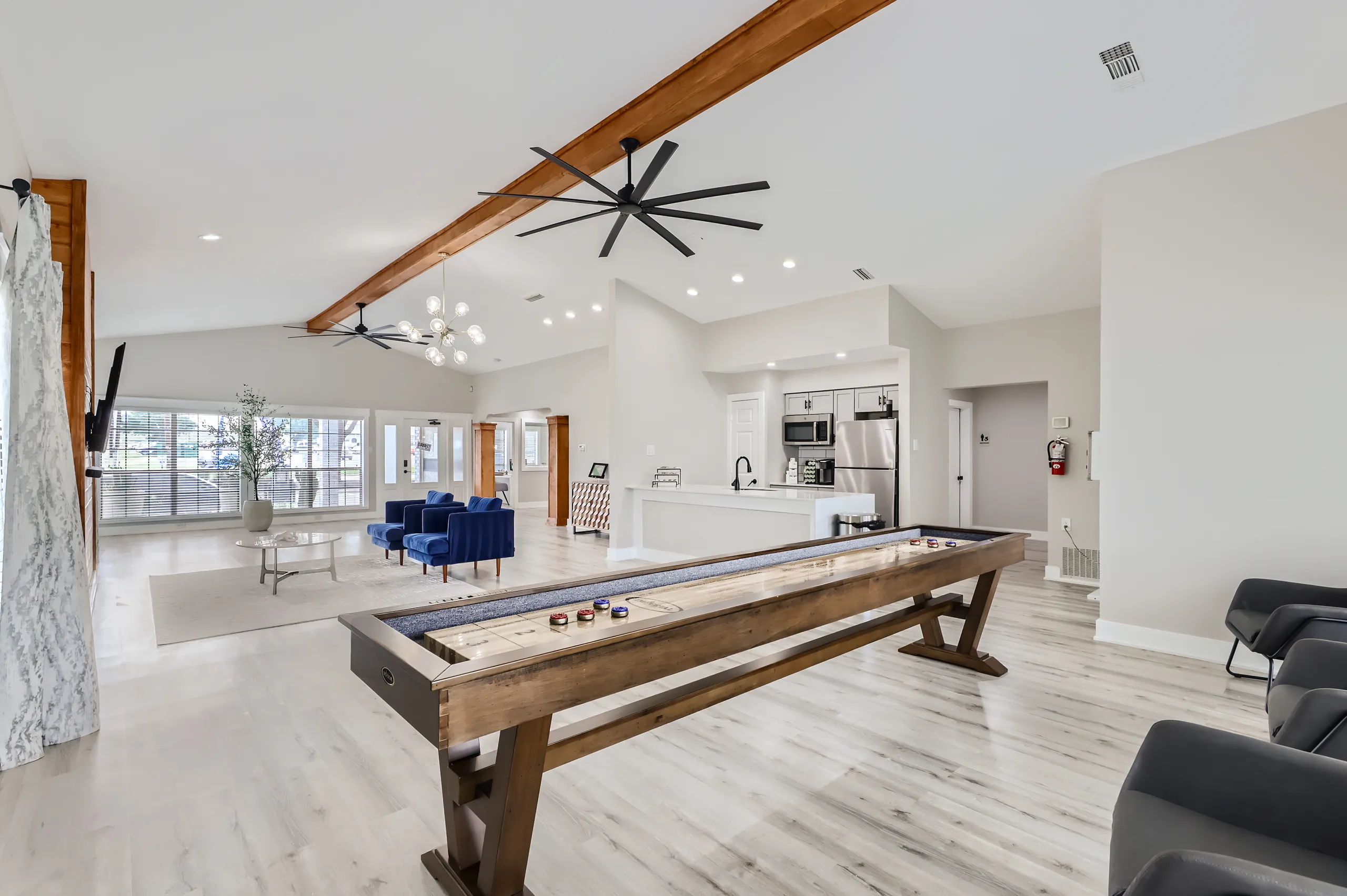 Clubhouse lounge with shuffleboard table and open kitchen