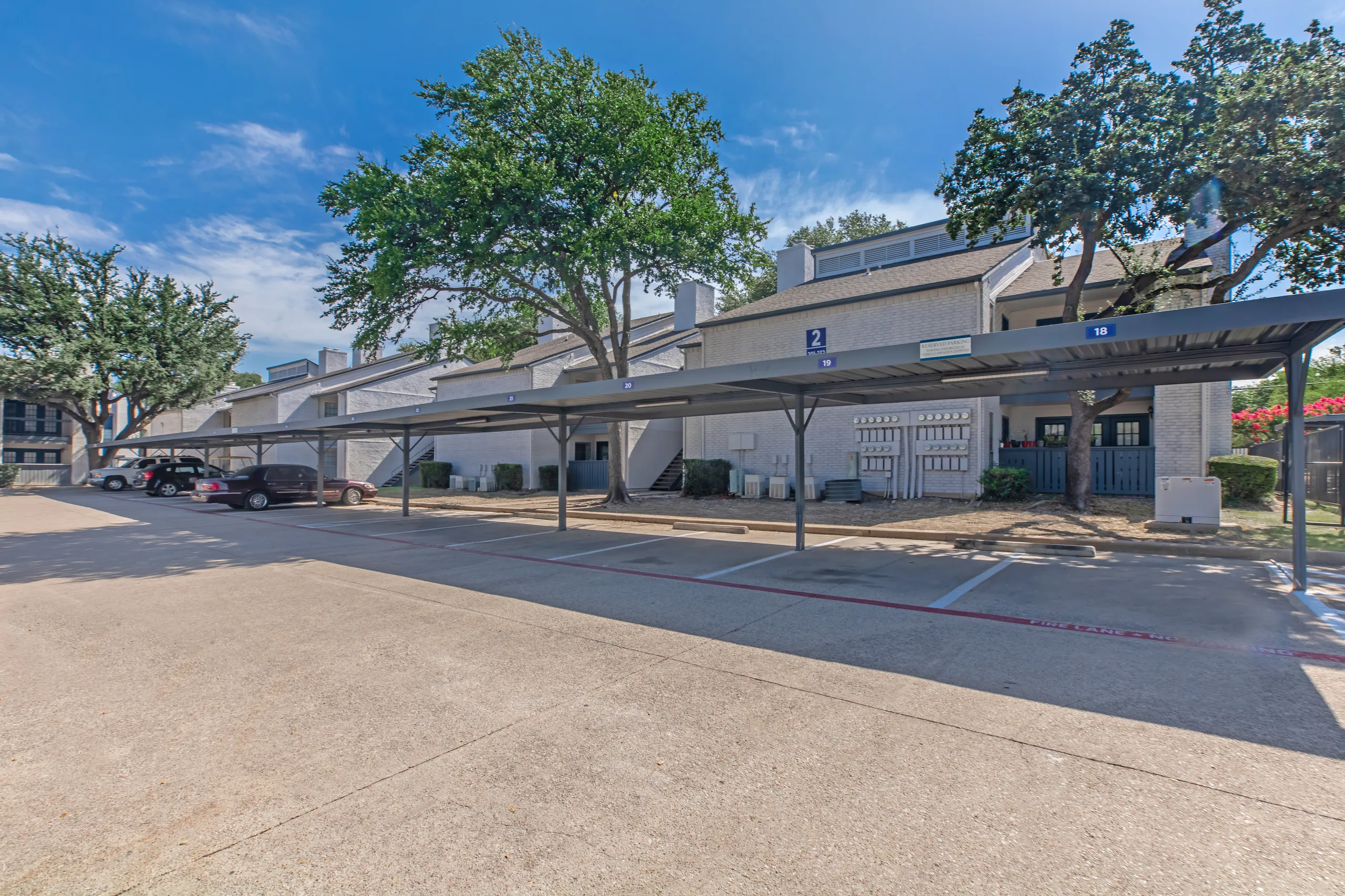 Covered parking carports alongside apartment buildings