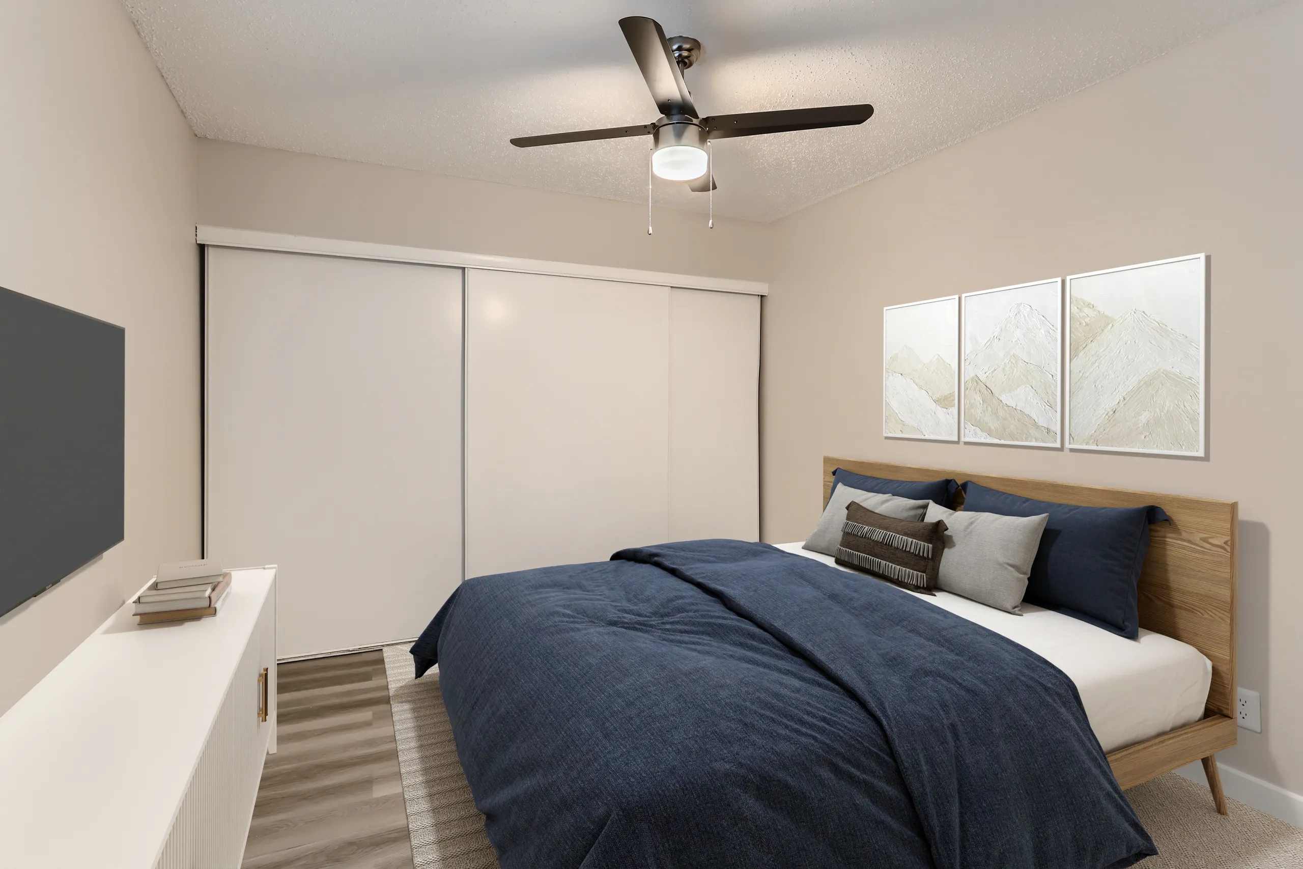 Renovated primary bedroom with wood platform bed and sliding closet doors