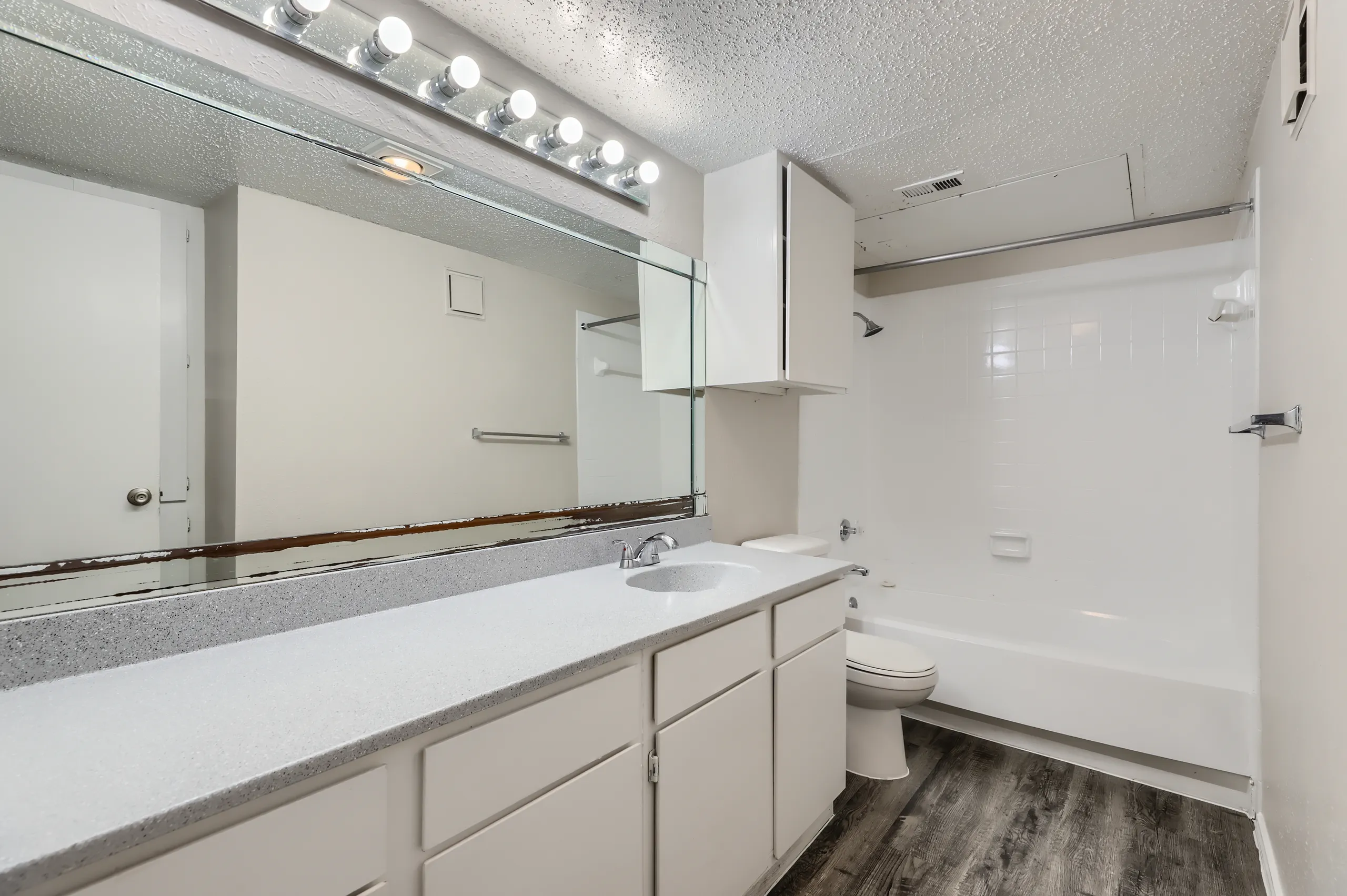 Primary bathroom with tub-shower combo and single-sink vanity