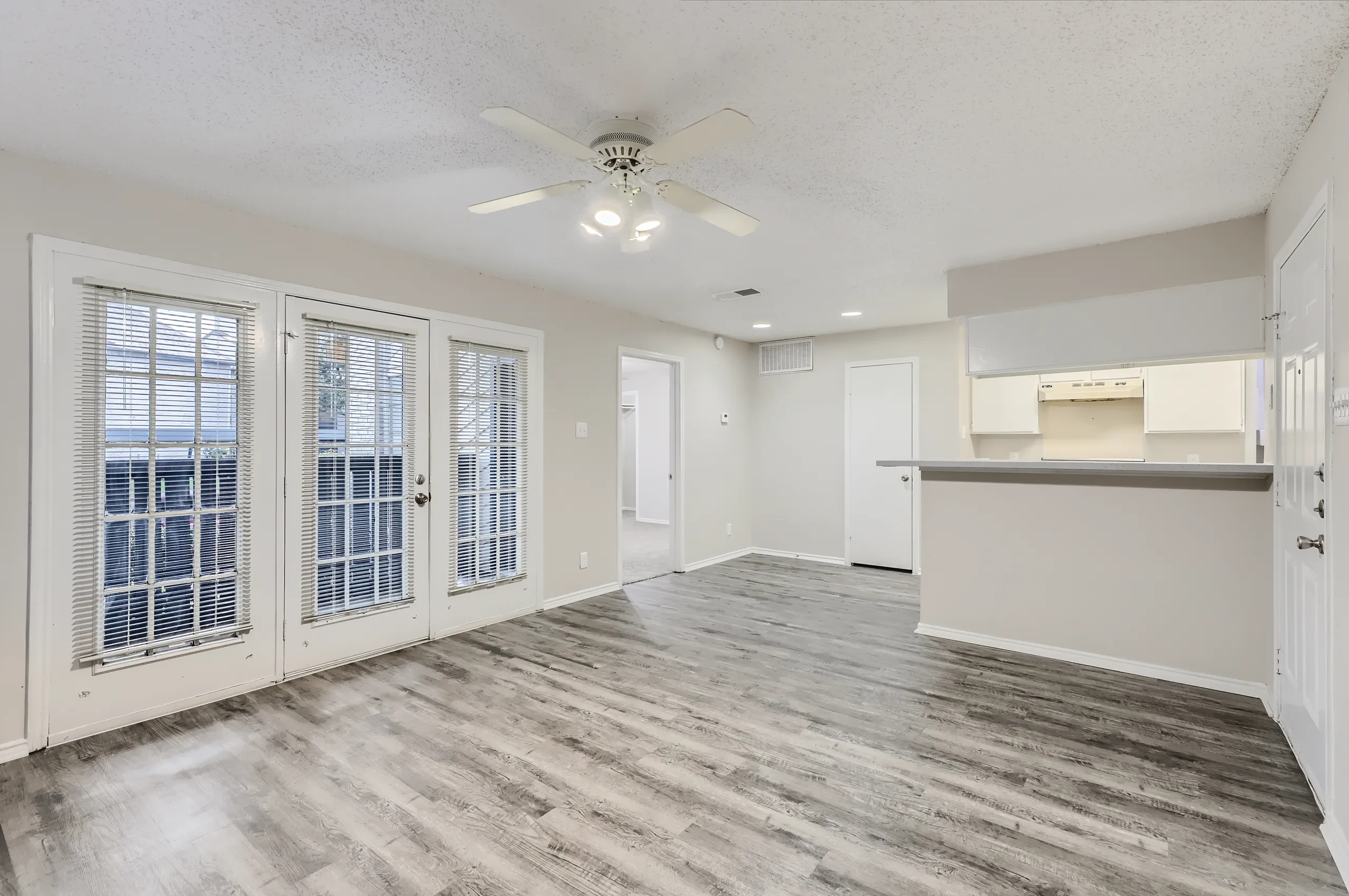 Living room with French doors and pass-through view to the kitchen