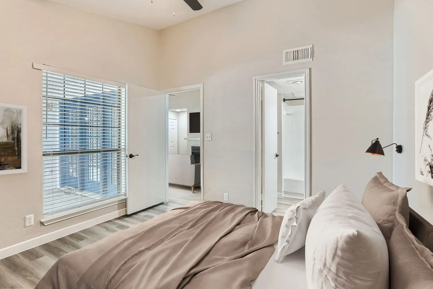 Primary bedroom with en-suite bathroom access and city-facing window