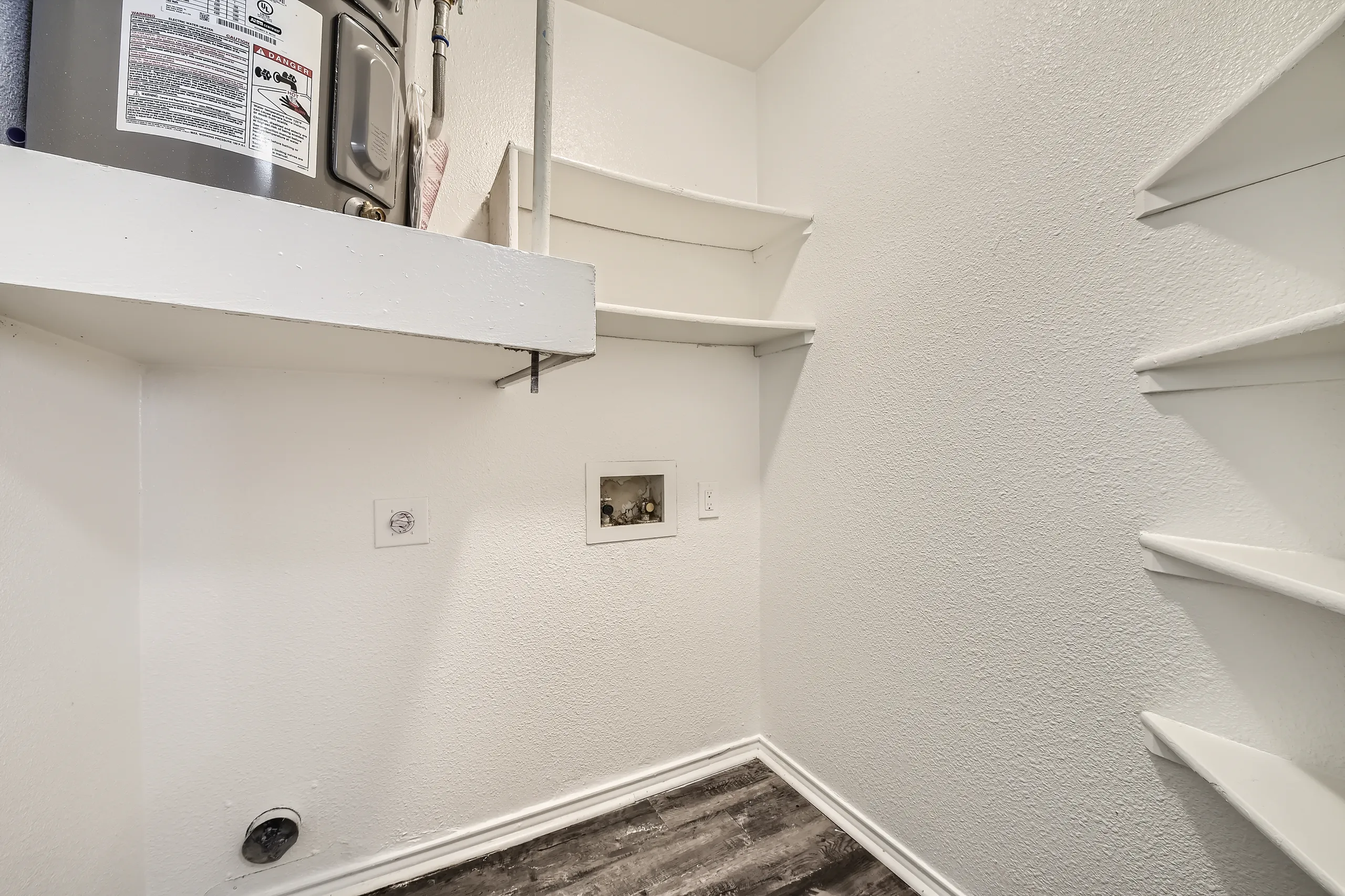 In-unit laundry closet with water heater and washer-dryer hookups