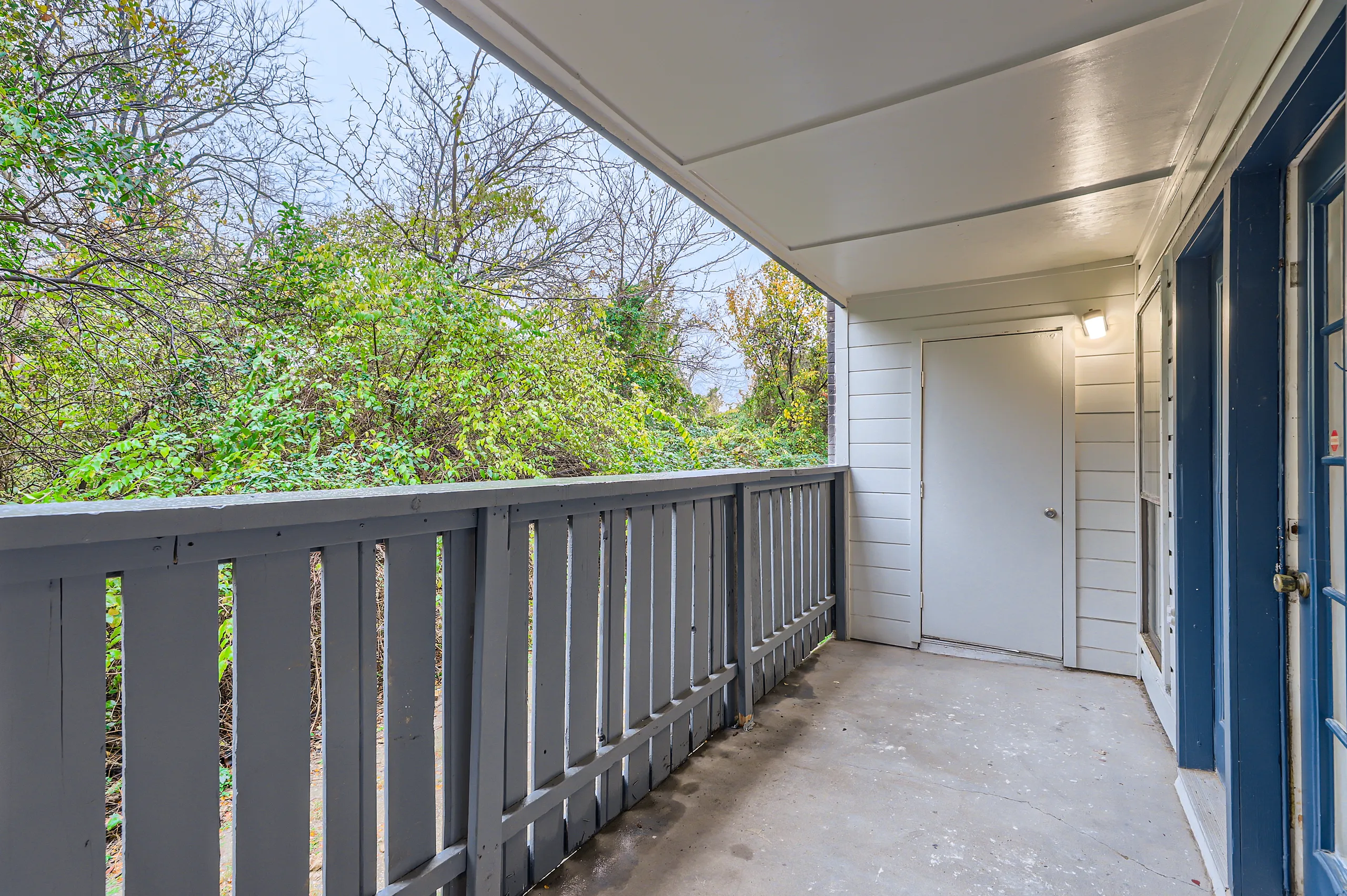 Private balcony overlooking mature trees and greenery