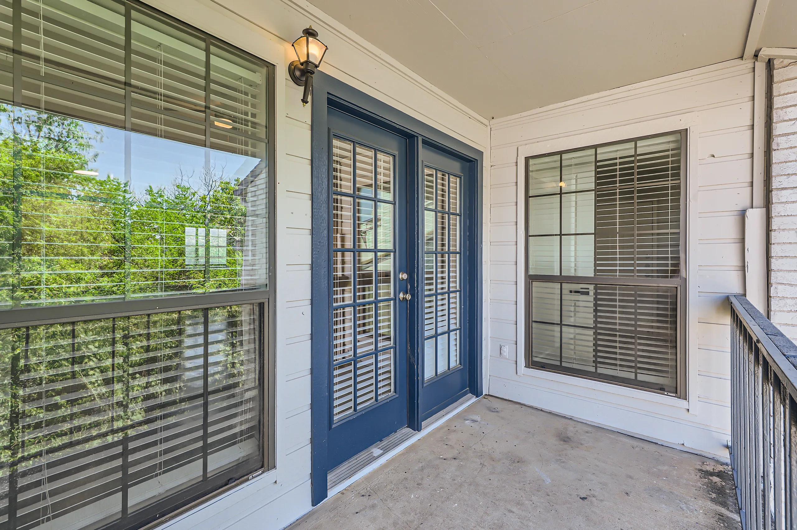 Private balcony with French doors and tree-lined view