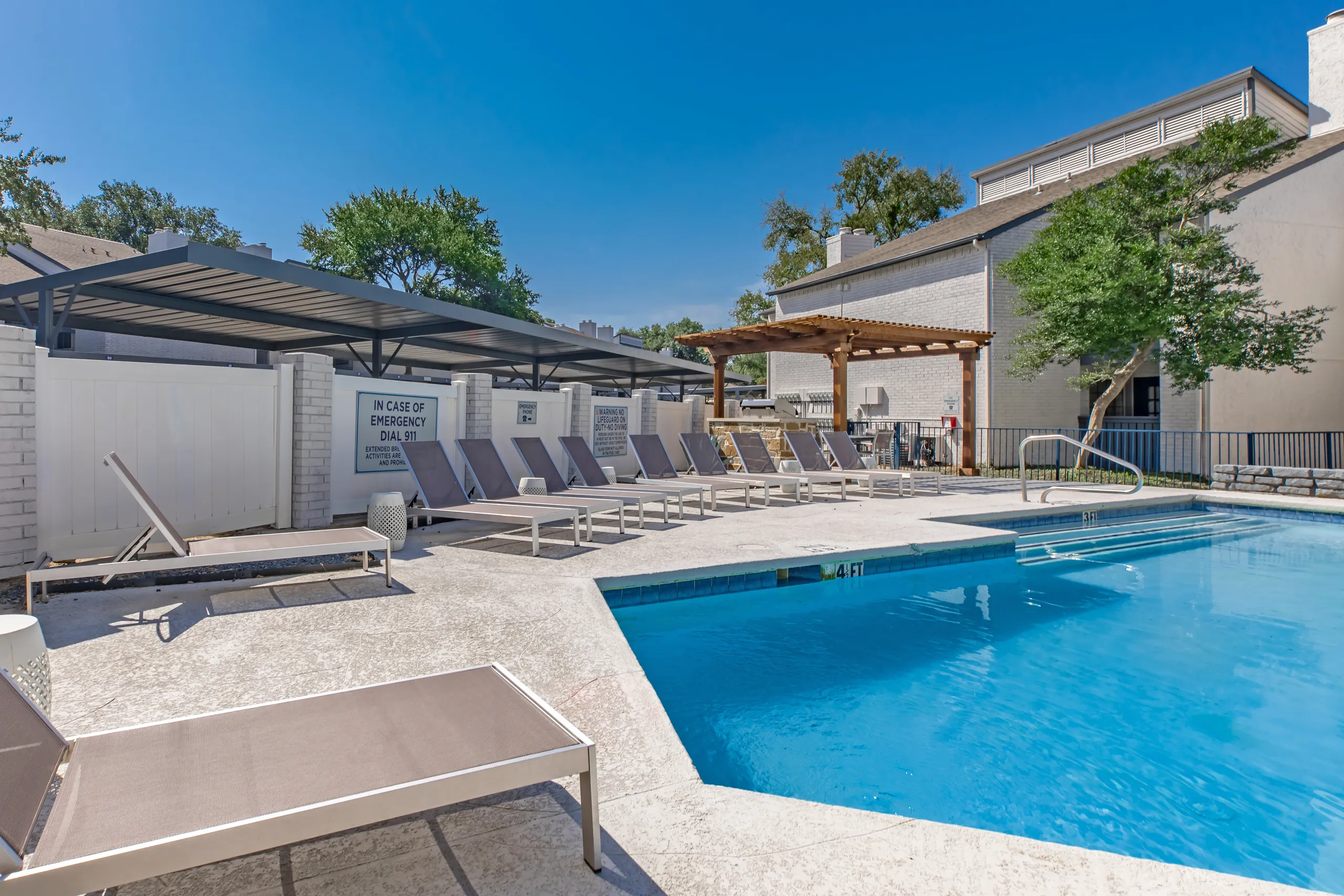Poolside lounge chairs with covered seating area