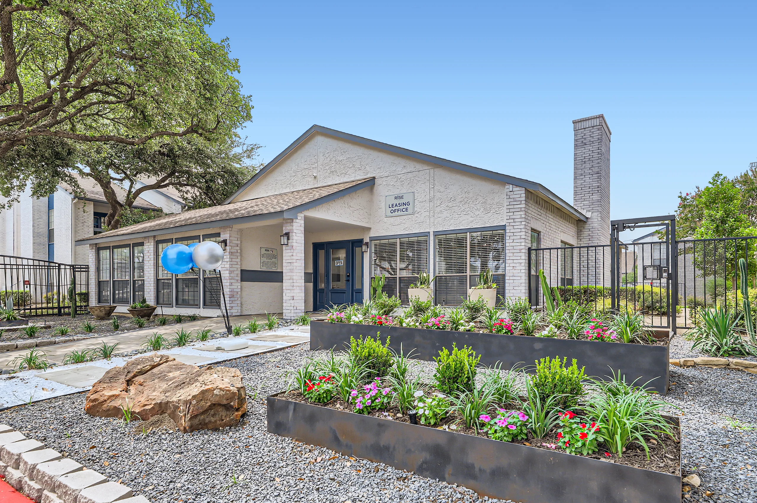 Rise leasing office exterior with landscaped entrance
