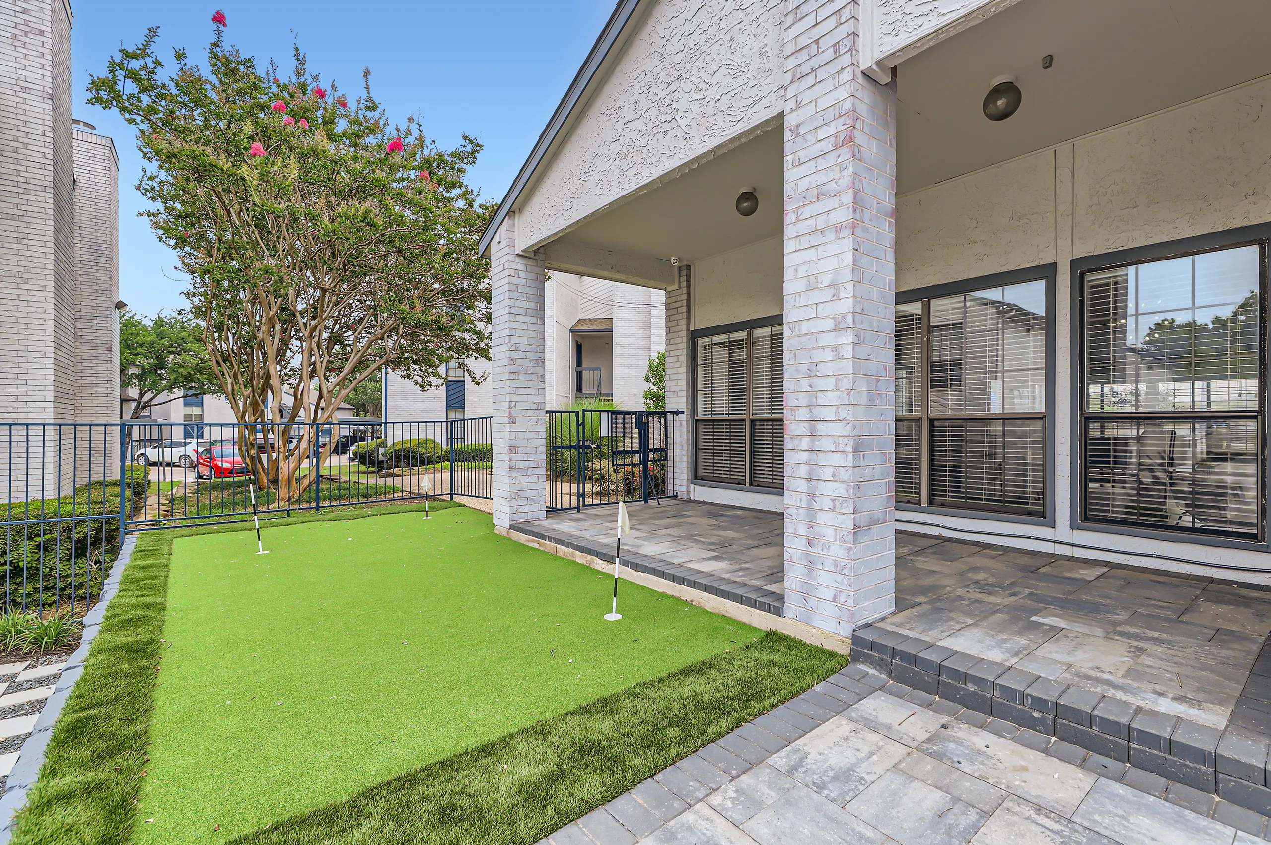 Outdoor putting green patio next to clubhouse