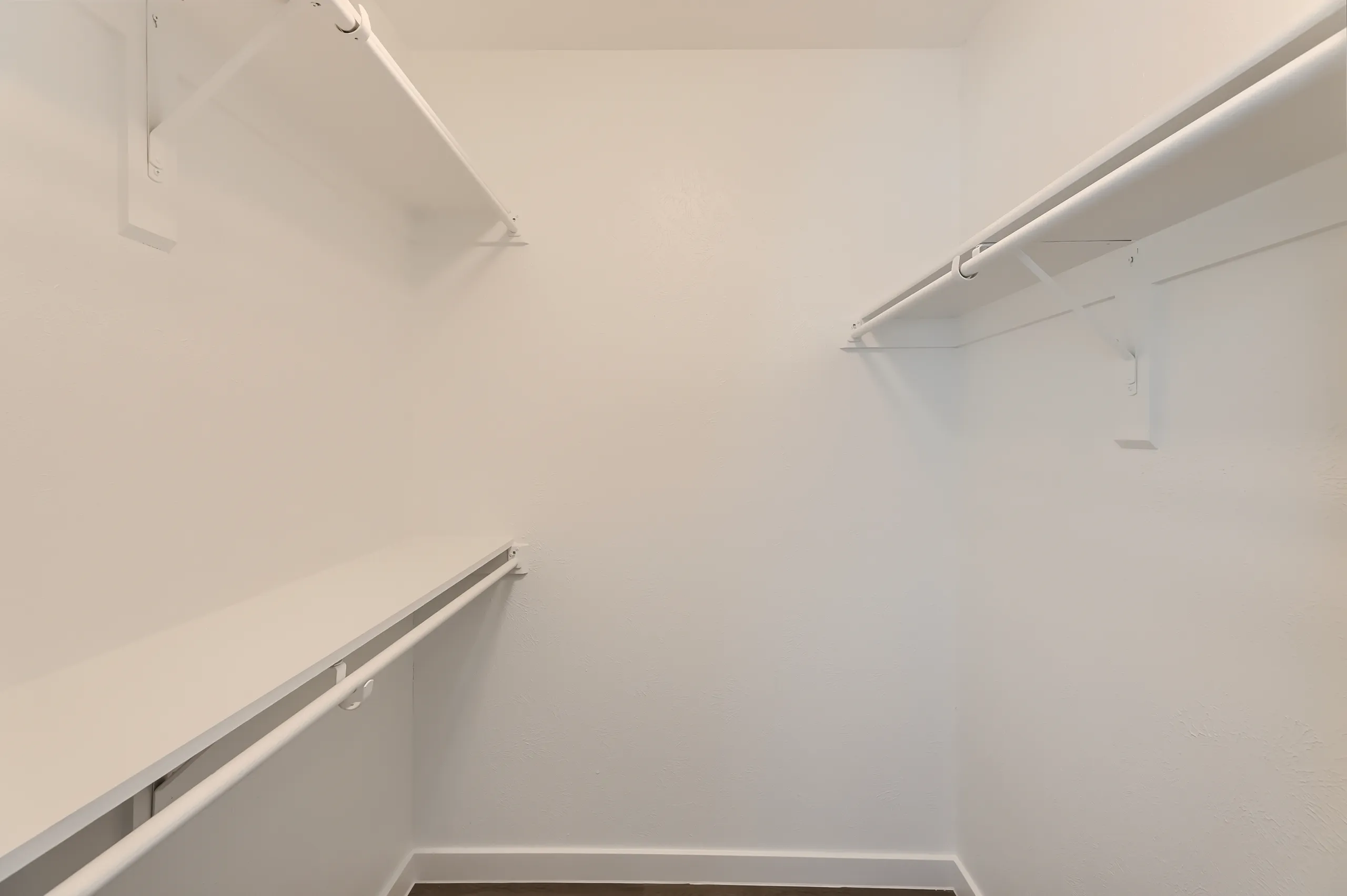 Walk-in closet with built-in shelving and hanging rods