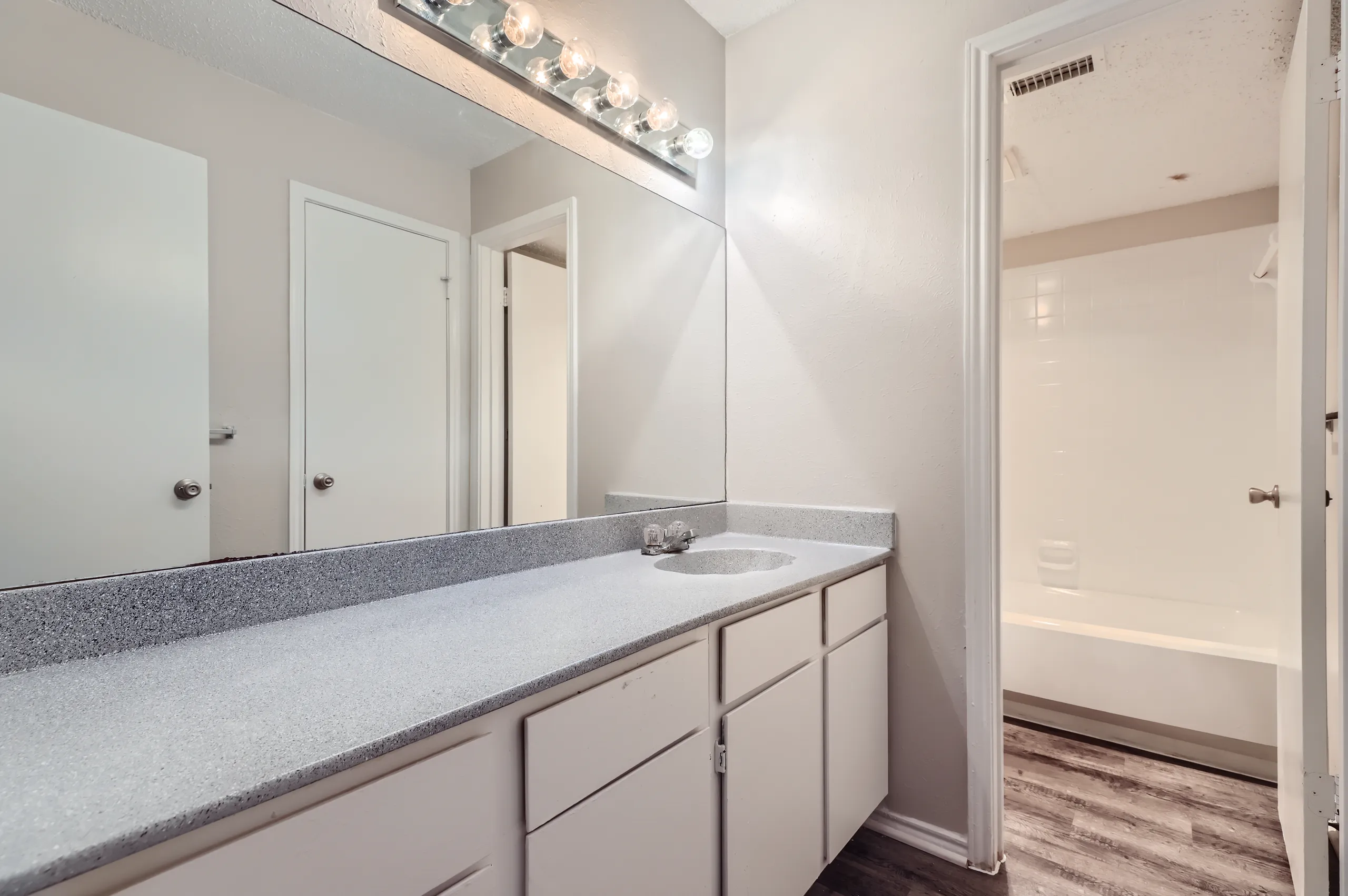 Bathroom with vanity and tub-shower combo