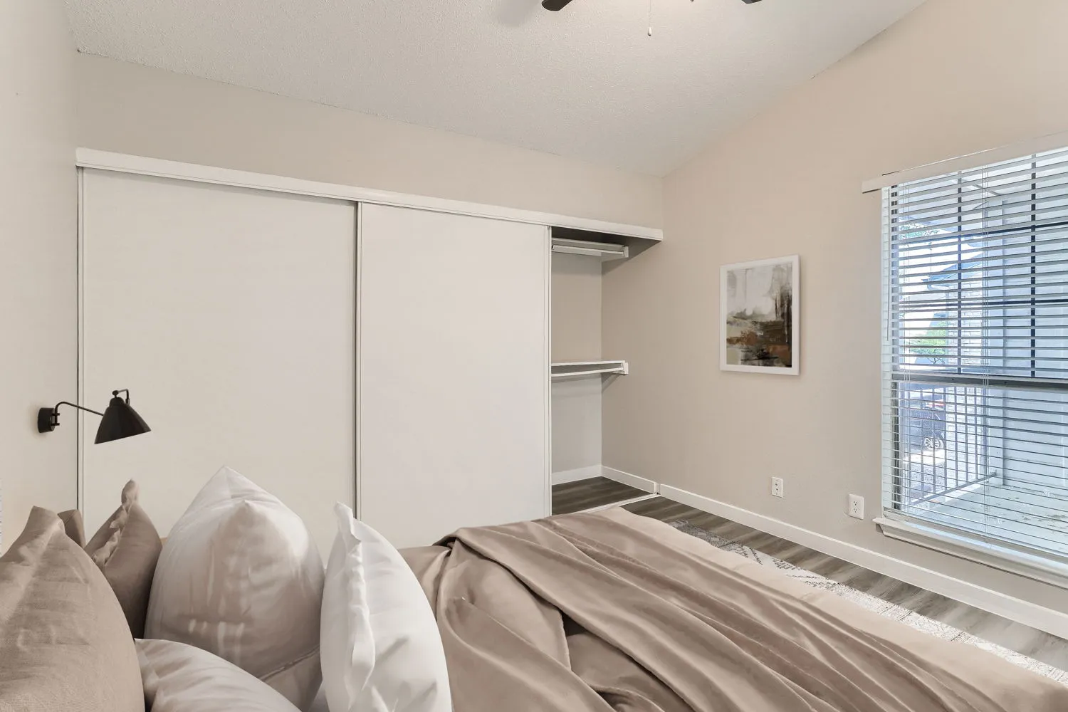 Primary bedroom with sliding closet doors and walk-in closet storage