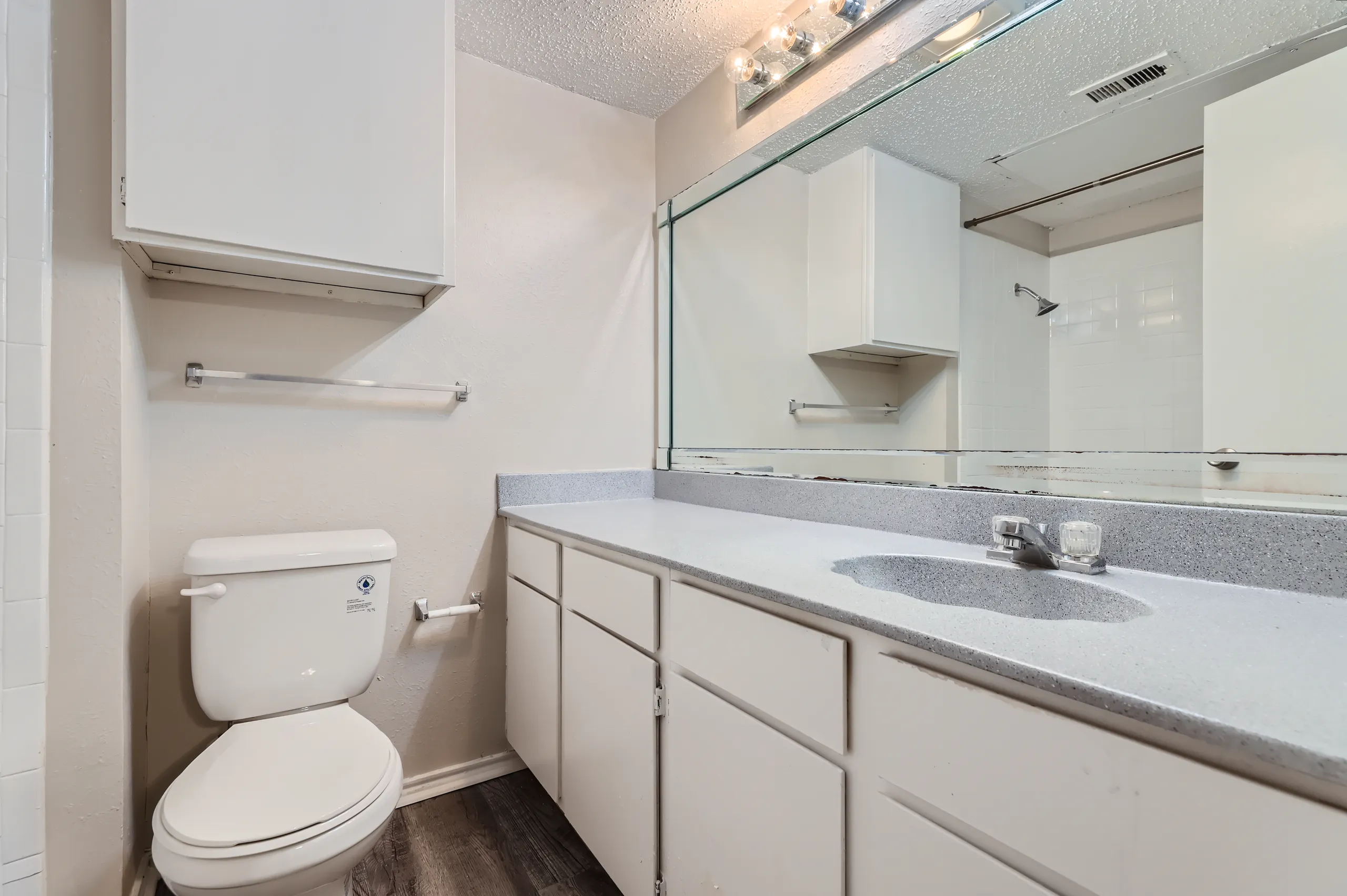 Primary bathroom with single-sink vanity and tub-shower combo