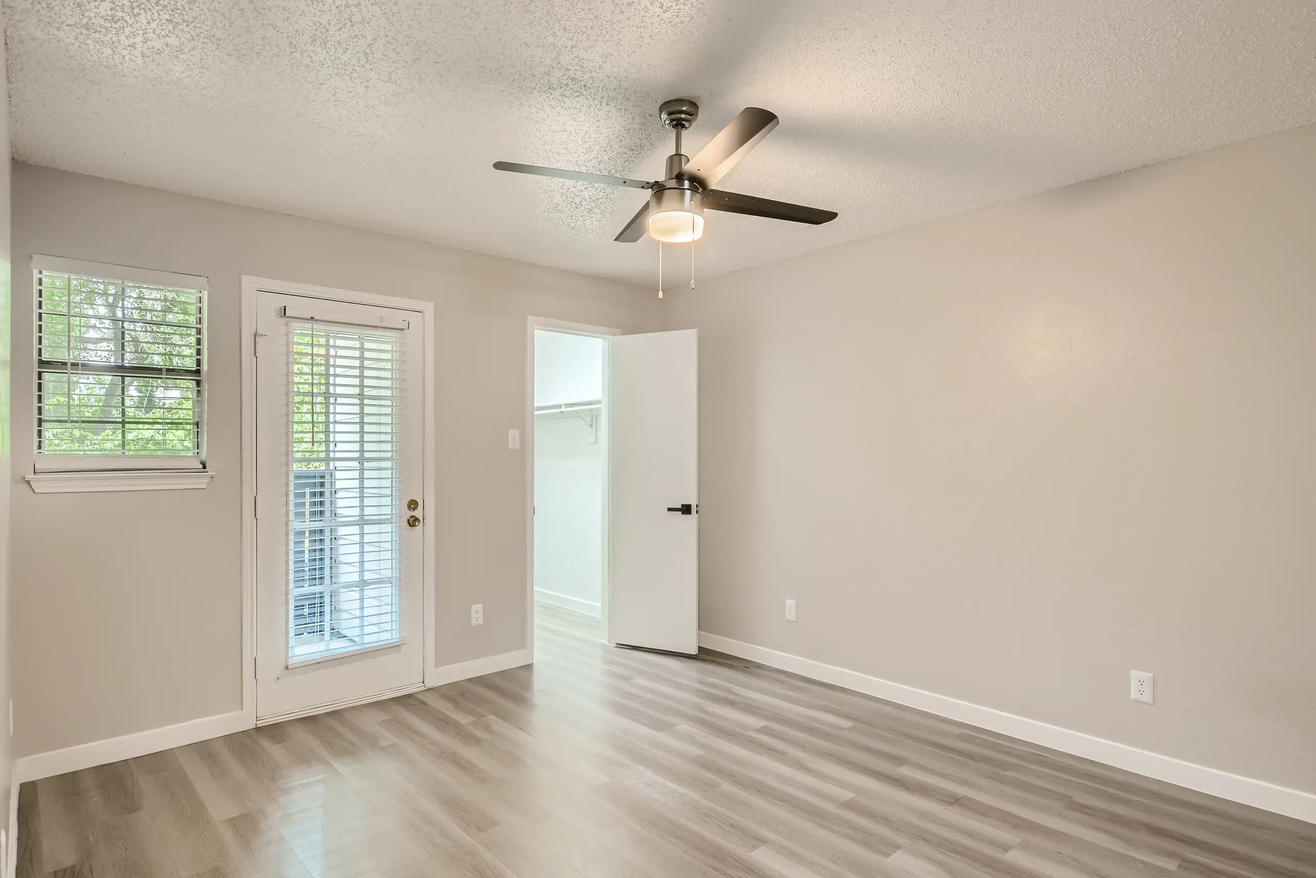 Bedroom with walk-in closet and private patio door