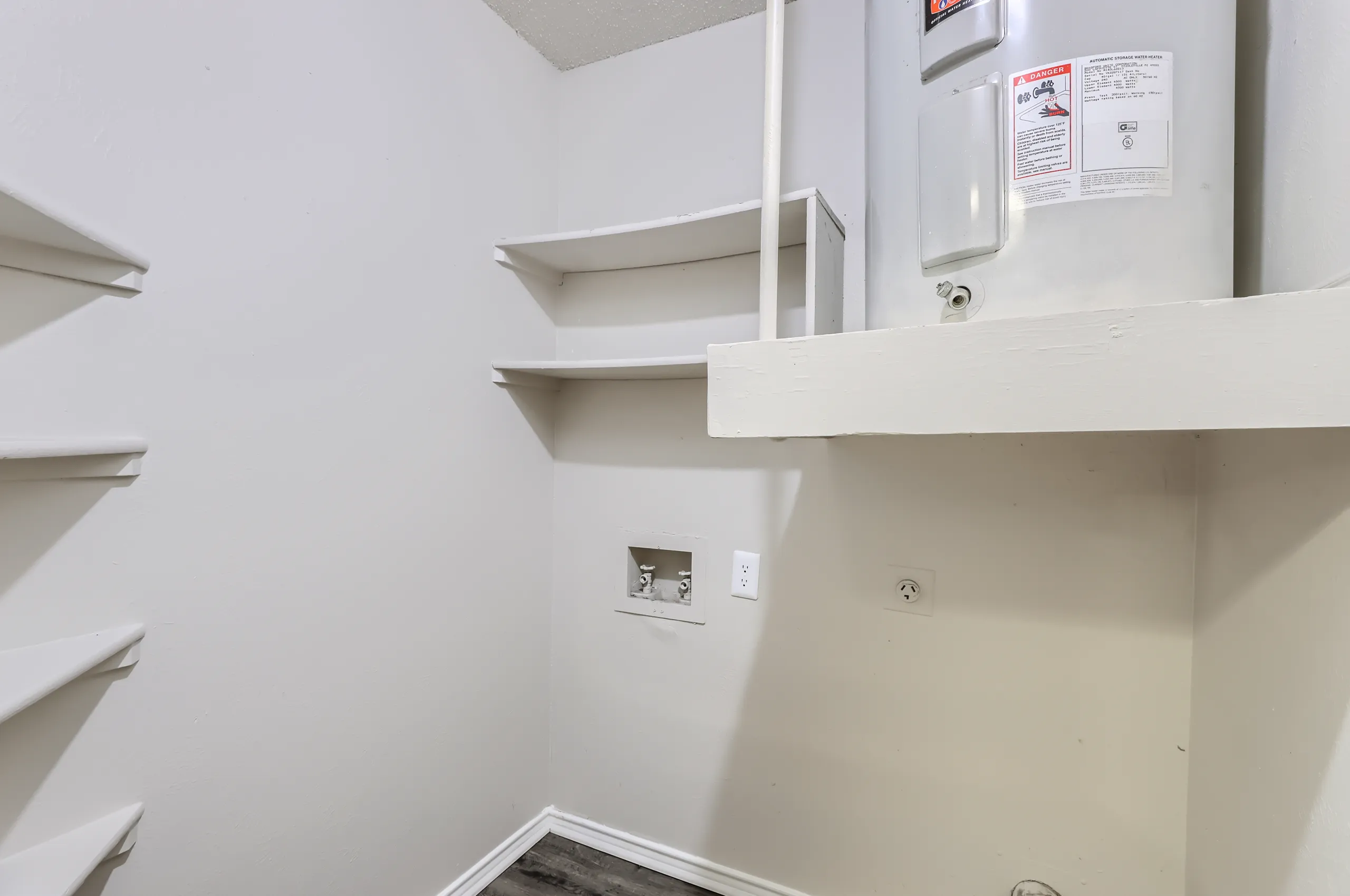 In-unit laundry closet with water heater and washer-dryer hookups