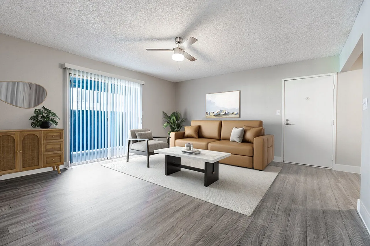 Living room, wood-style plank flooring, tan upholstered sofa, black coffee table, ceiling fan, vertical blinds