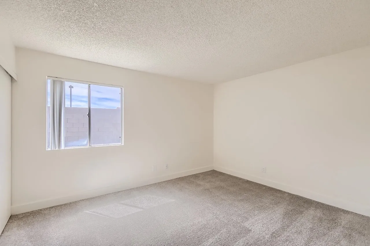 Bedroom, carpet flooring, single window with view, textured ceiling