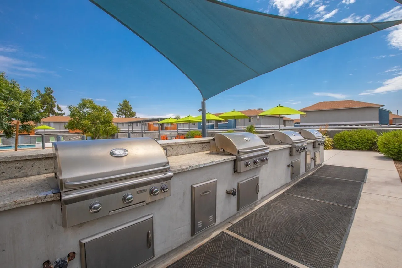 Rooftop grilling station, stainless steel grills, shade sail, community view