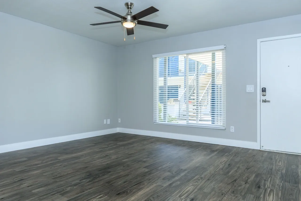 Bedroom, wood-style plank flooring, ceiling fan, large windows, white trim