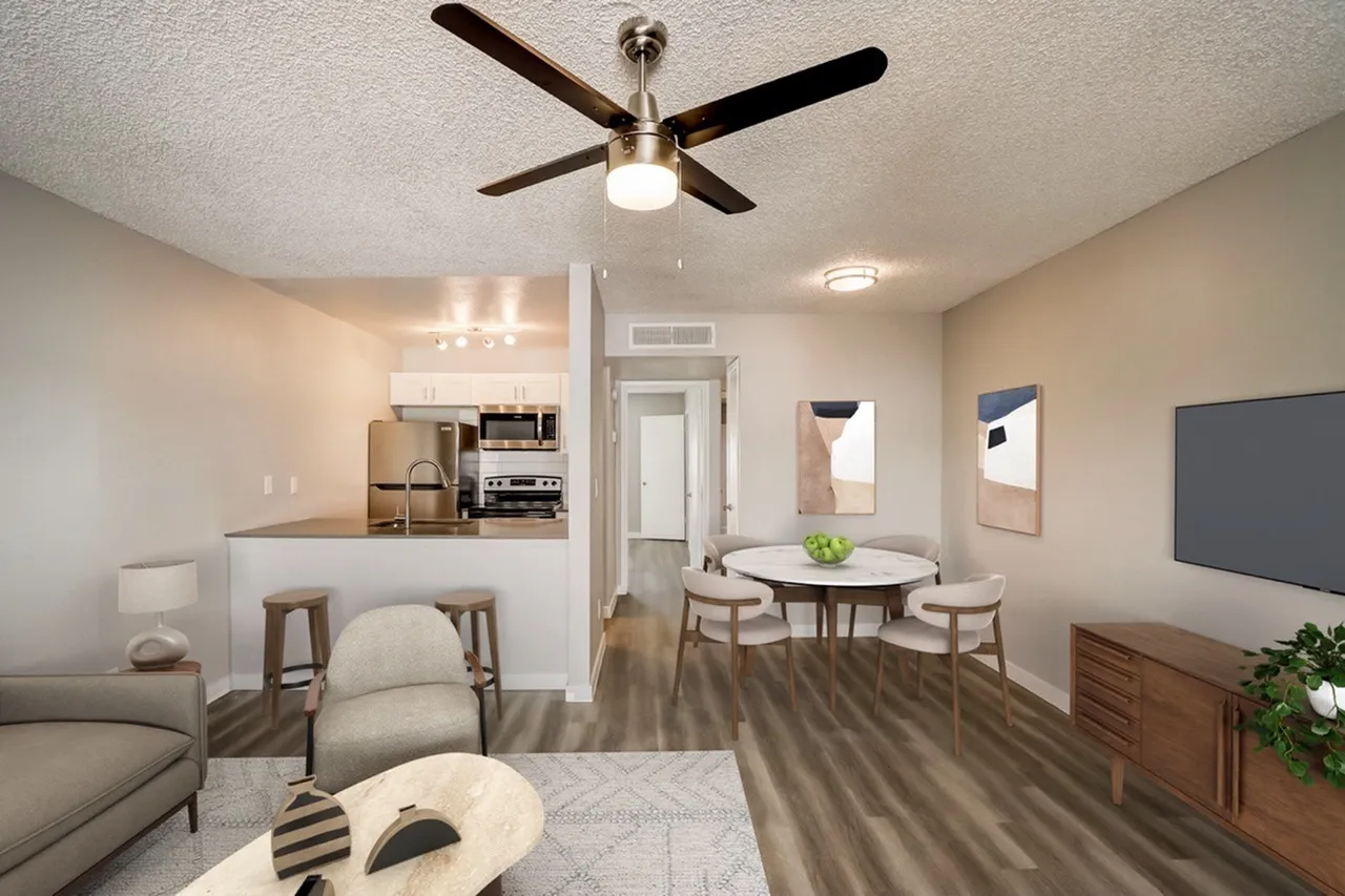 Living and dining area, wood-style plank flooring, ceiling fan with light, dining table with chairs