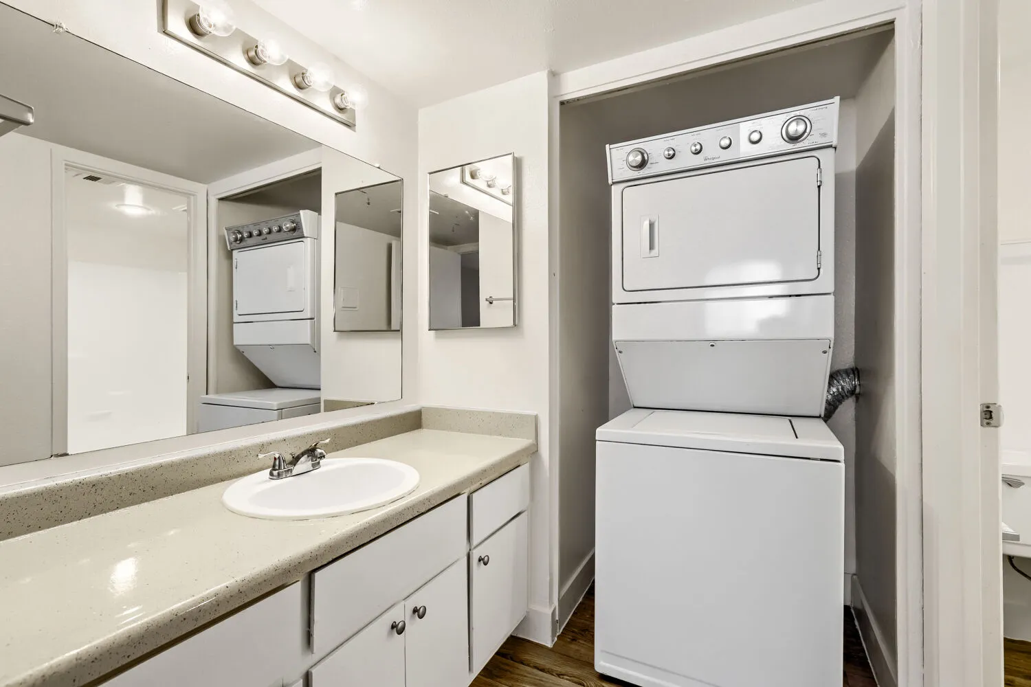 Primary bathroom vanity with in-unit stacked washer and dryer