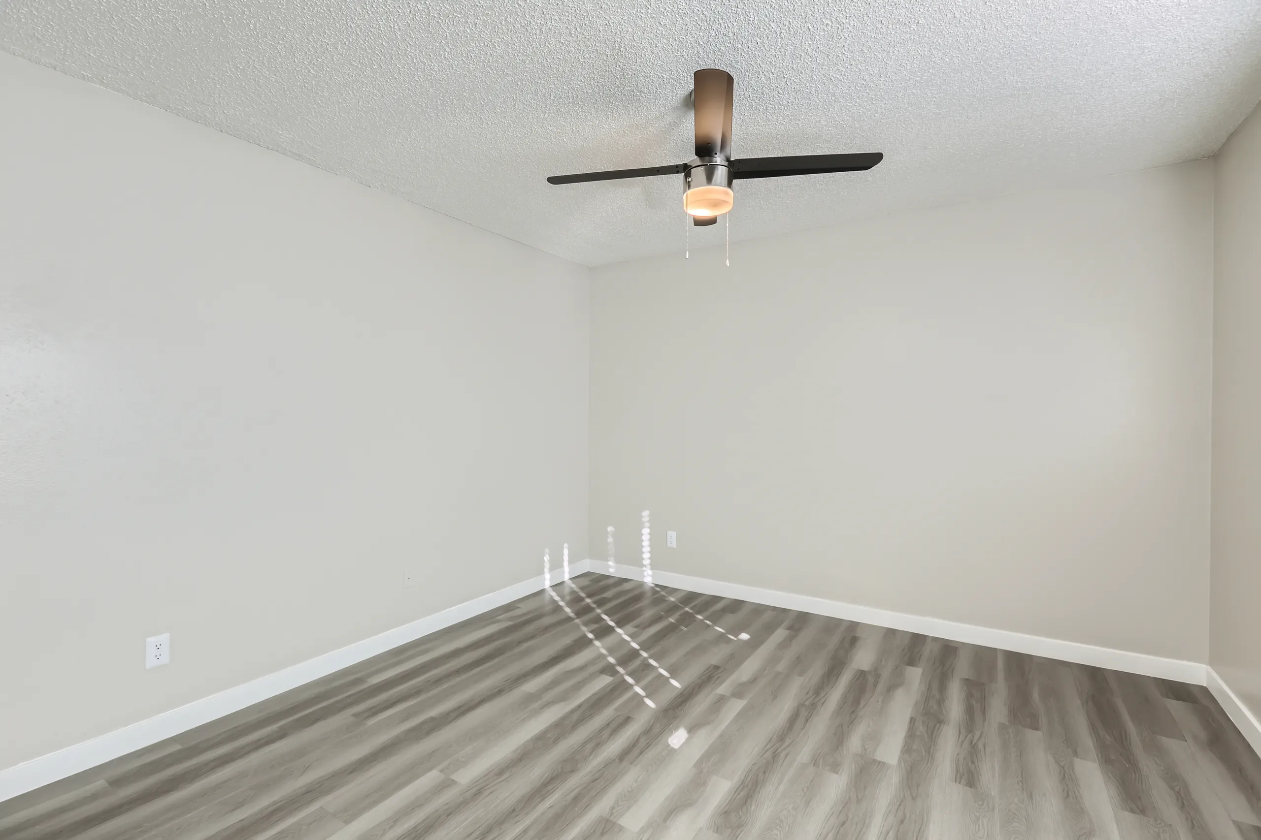 Bedroom with ceiling fan and wood-style plank flooring