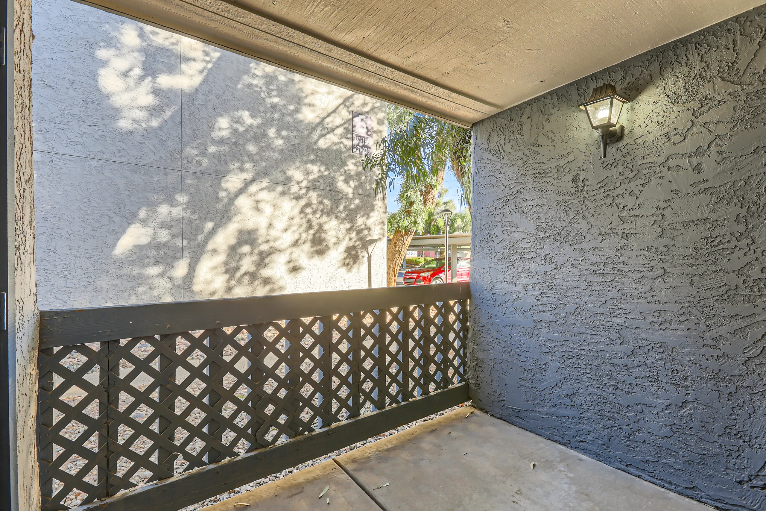 Private covered patio with lattice railing