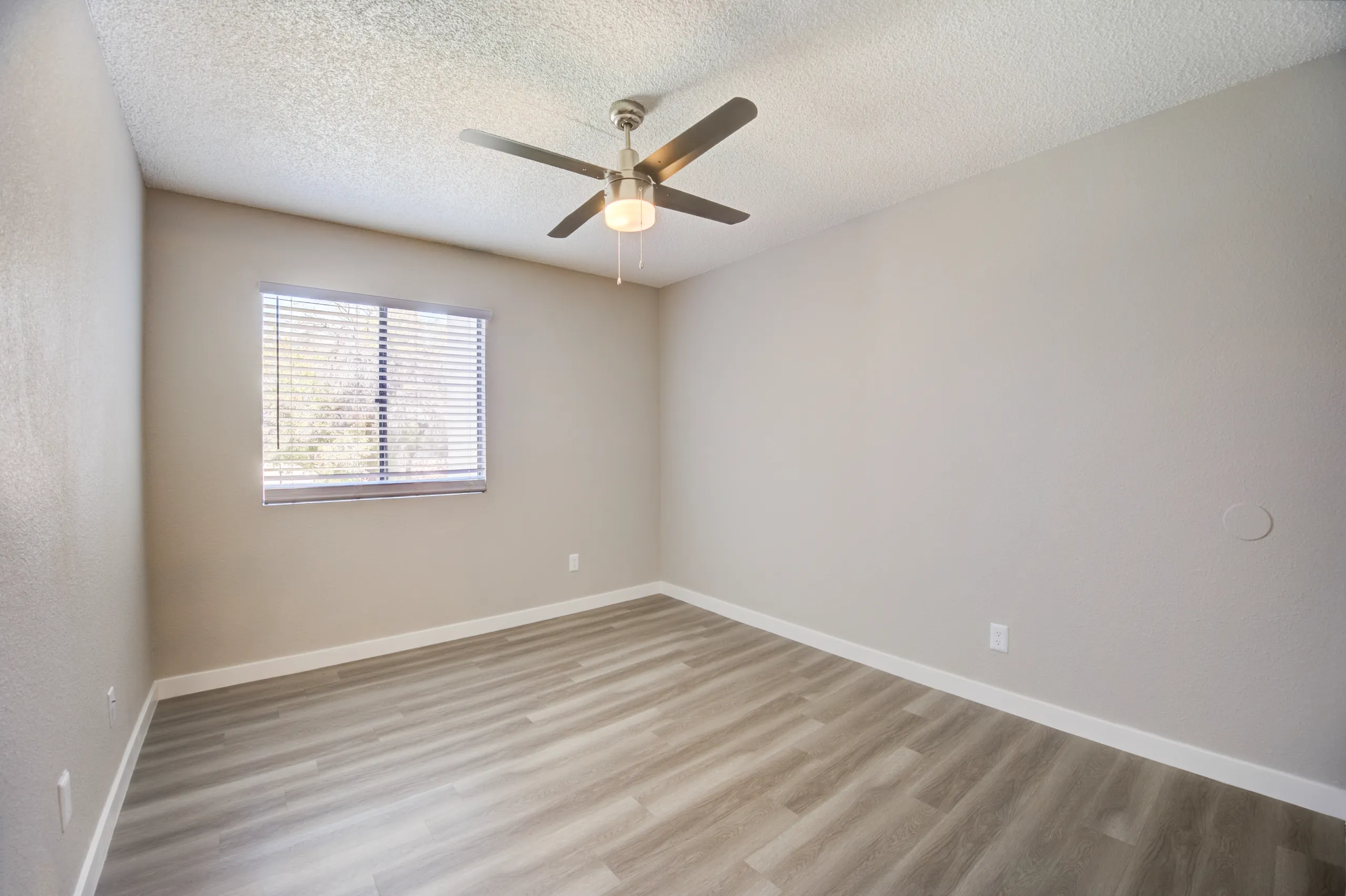 Bedroom with ceiling fan and wood-style plank flooring
