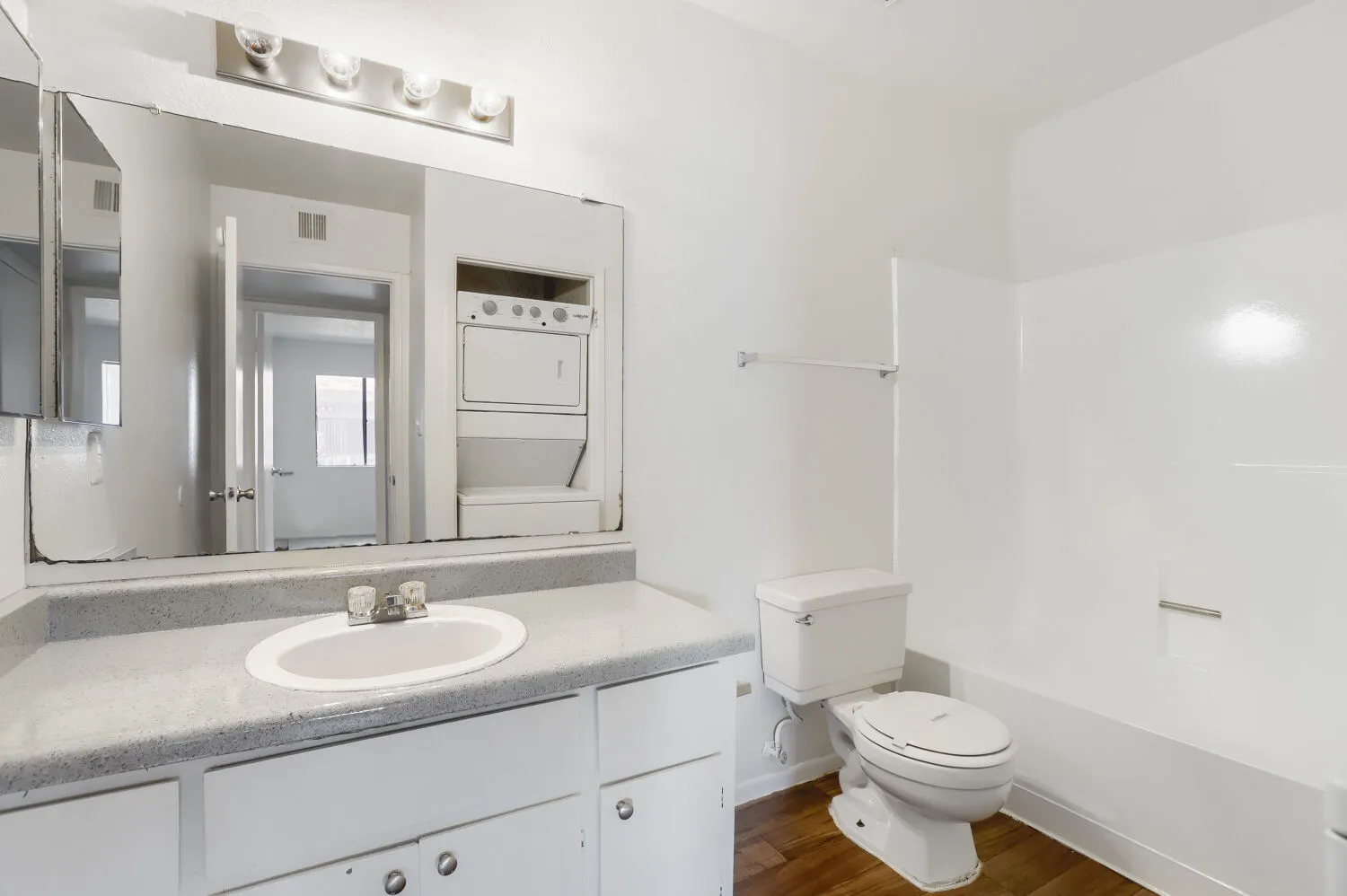 Bathroom vanity with in-unit stacked washer and dryer