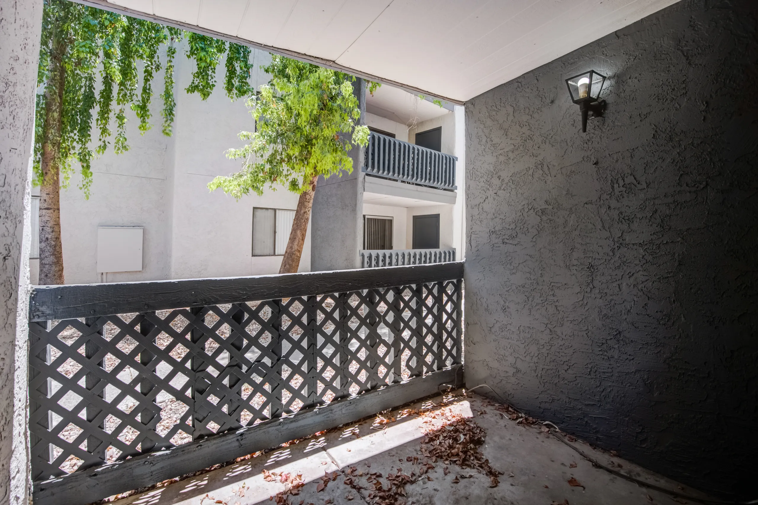 Private covered patio with lattice railing
