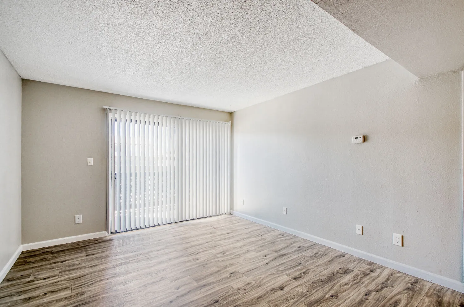 Living room with sliding glass door and private balcony