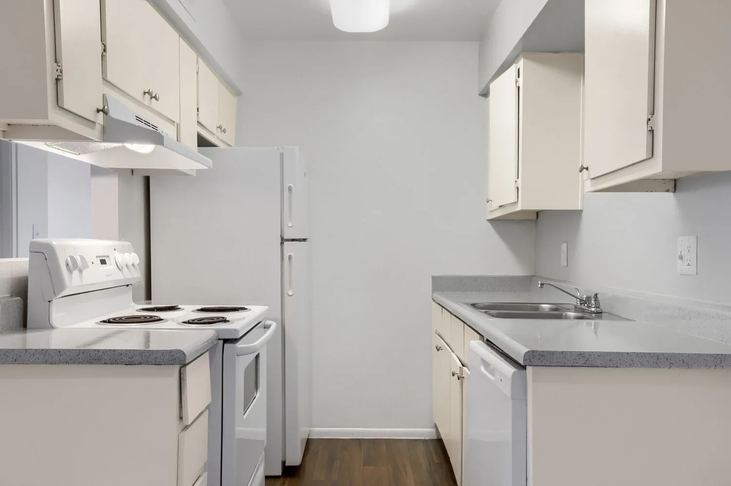 Kitchen with white cabinetry and electric range