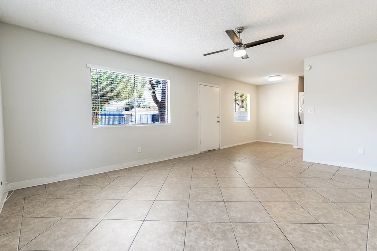 Living room, tile flooring, ceiling fan, large window