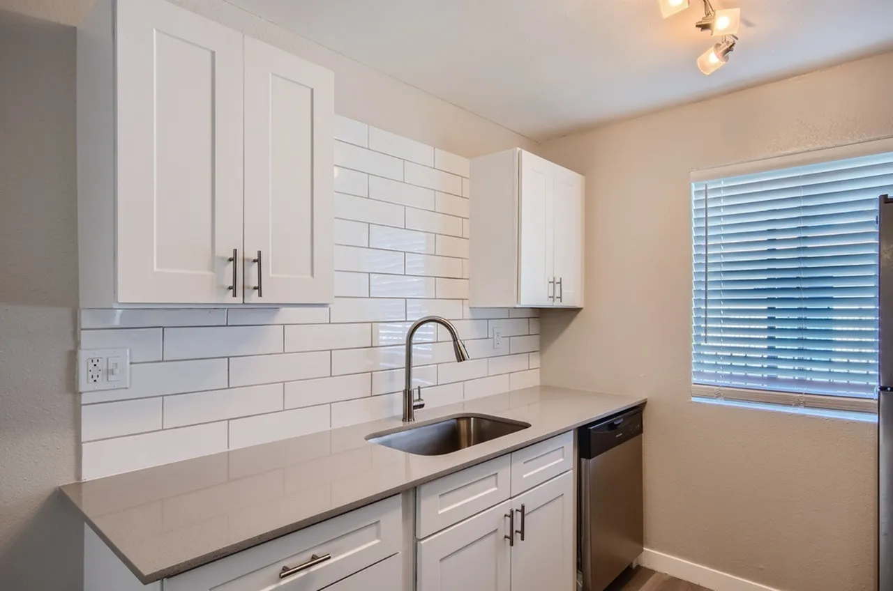Kitchen, white shaker cabinetry, subway tile backsplash, stainless sink and faucet, quartz countertops