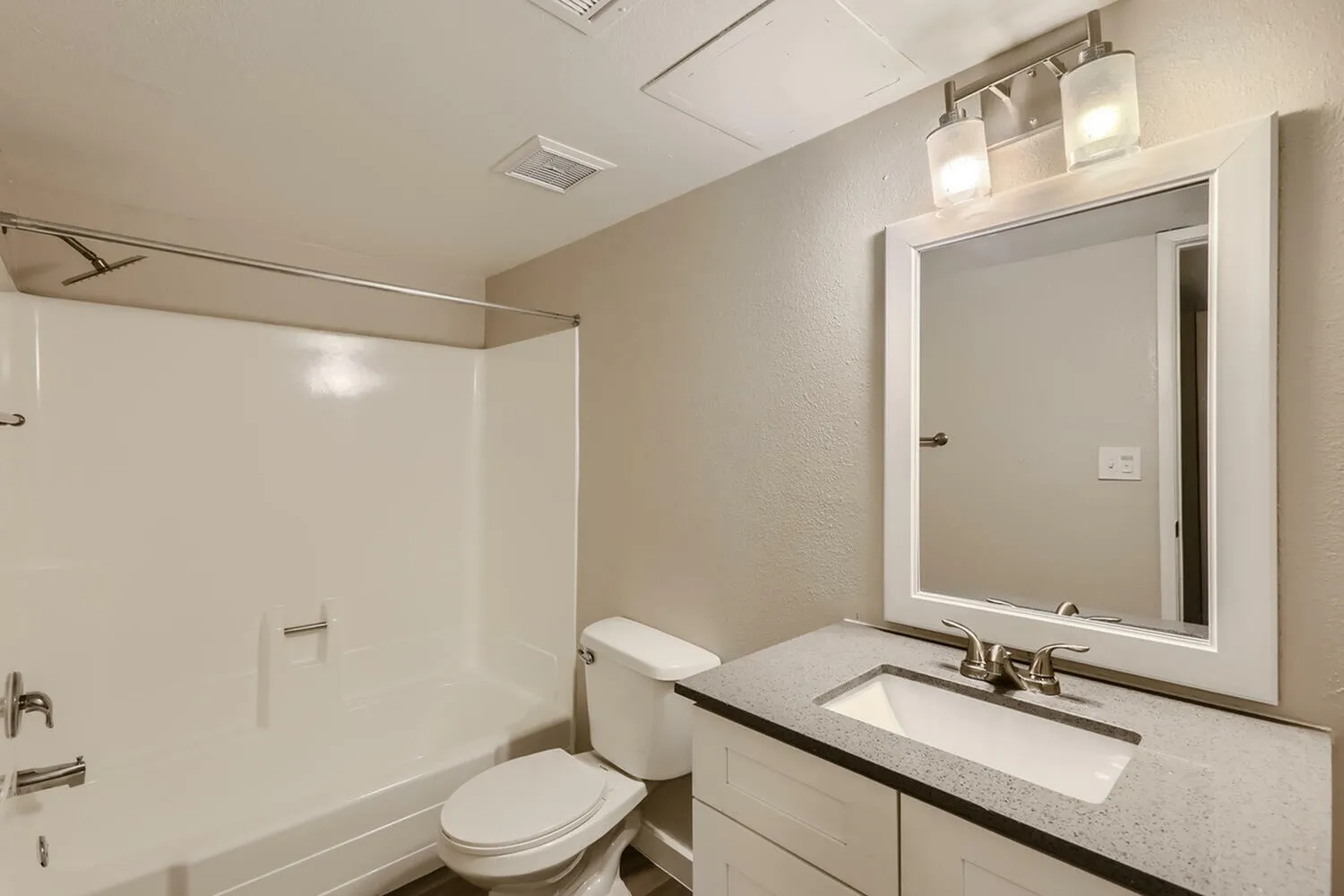 Bathroom, white framed mirror, quartz countertops, vessel sink, chrome fixtures