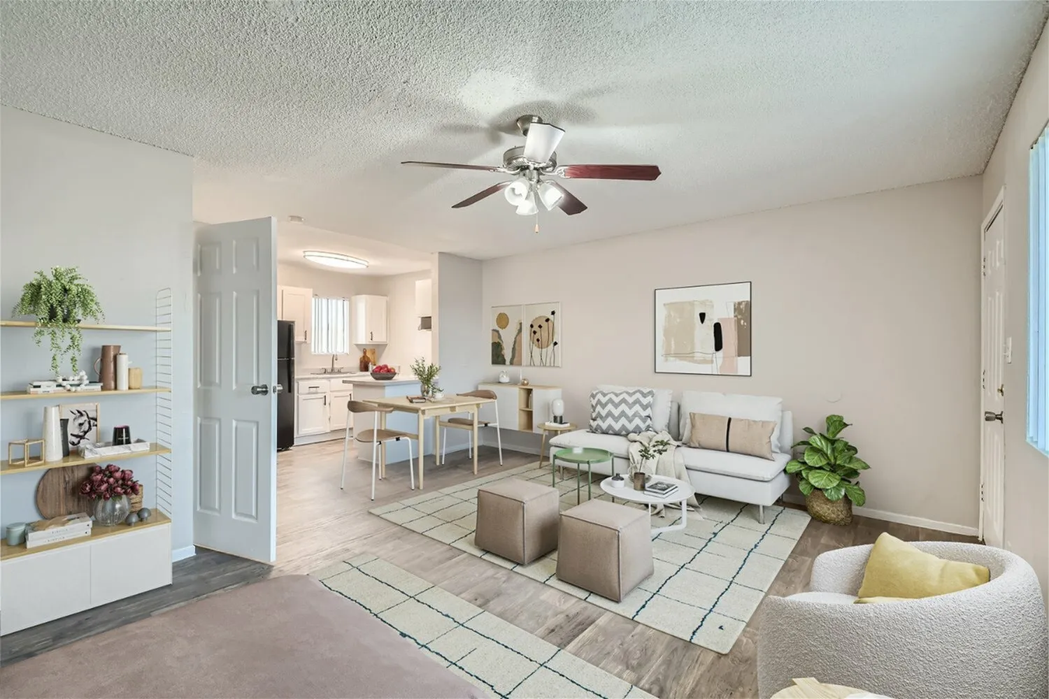 Living room and dining area, wood-style plank flooring, ceiling fan, neutral upholstery, area rugs