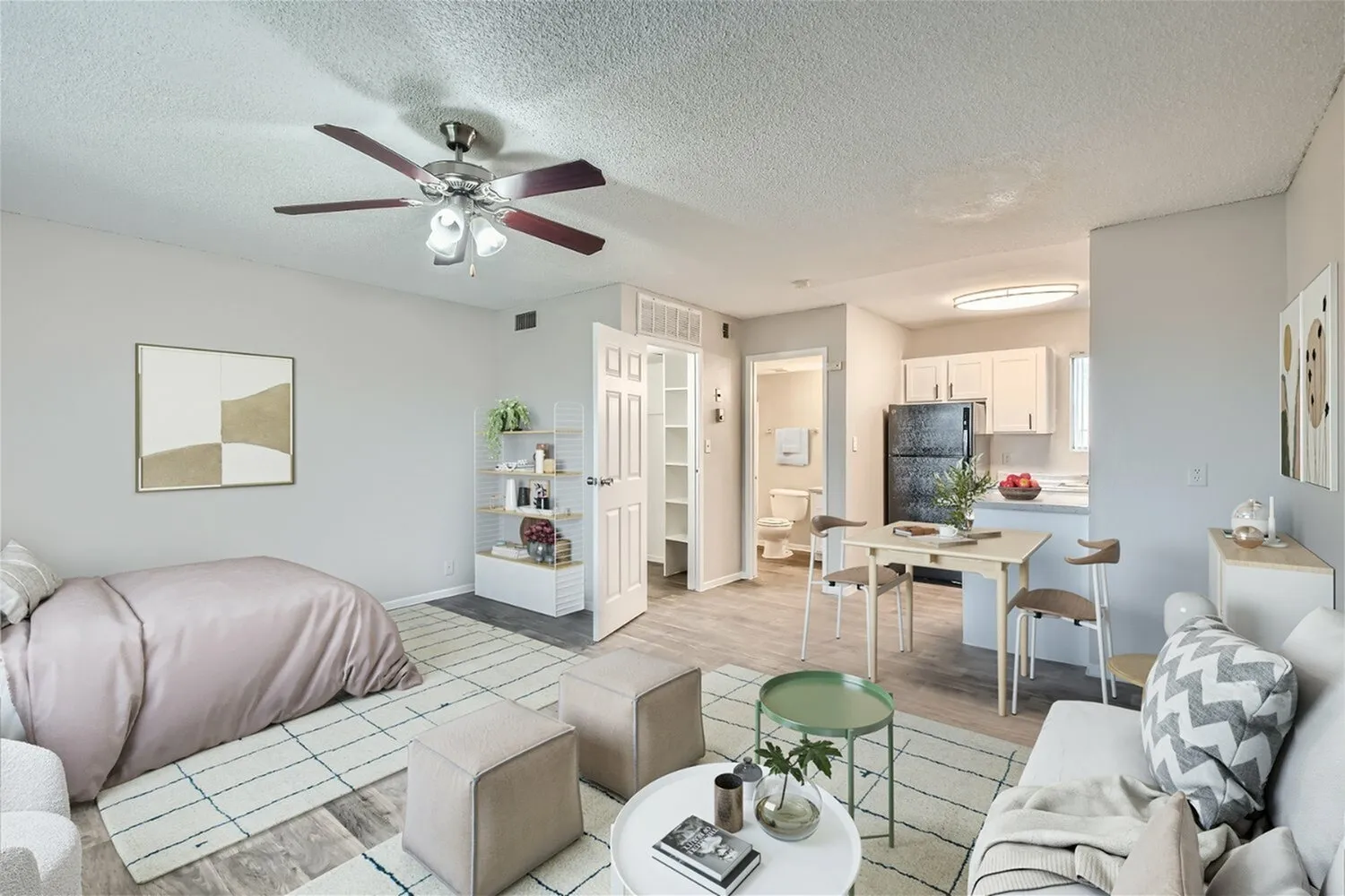 Studio apartment, wood-style plank flooring, ceiling fan, sleeping and living areas