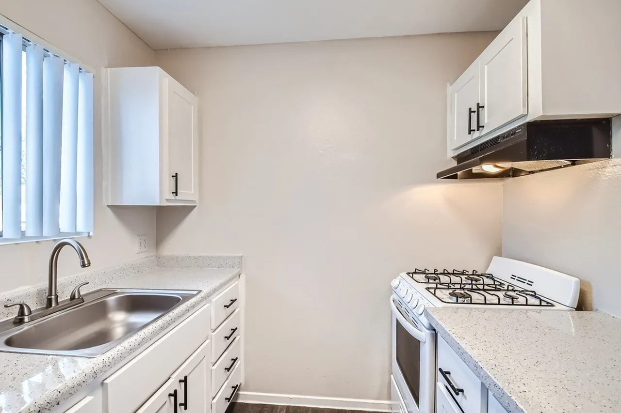 Kitchen, white shaker cabinetry, quartz countertops, stainless appliances, gas range