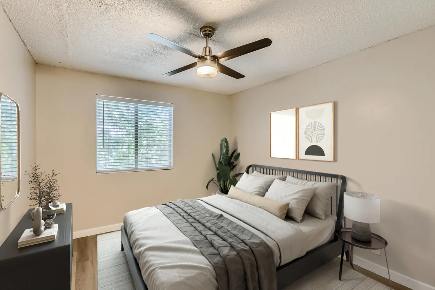 Primary bedroom, brass ceiling fan, window blinds, wood-style plank flooring, potted plant