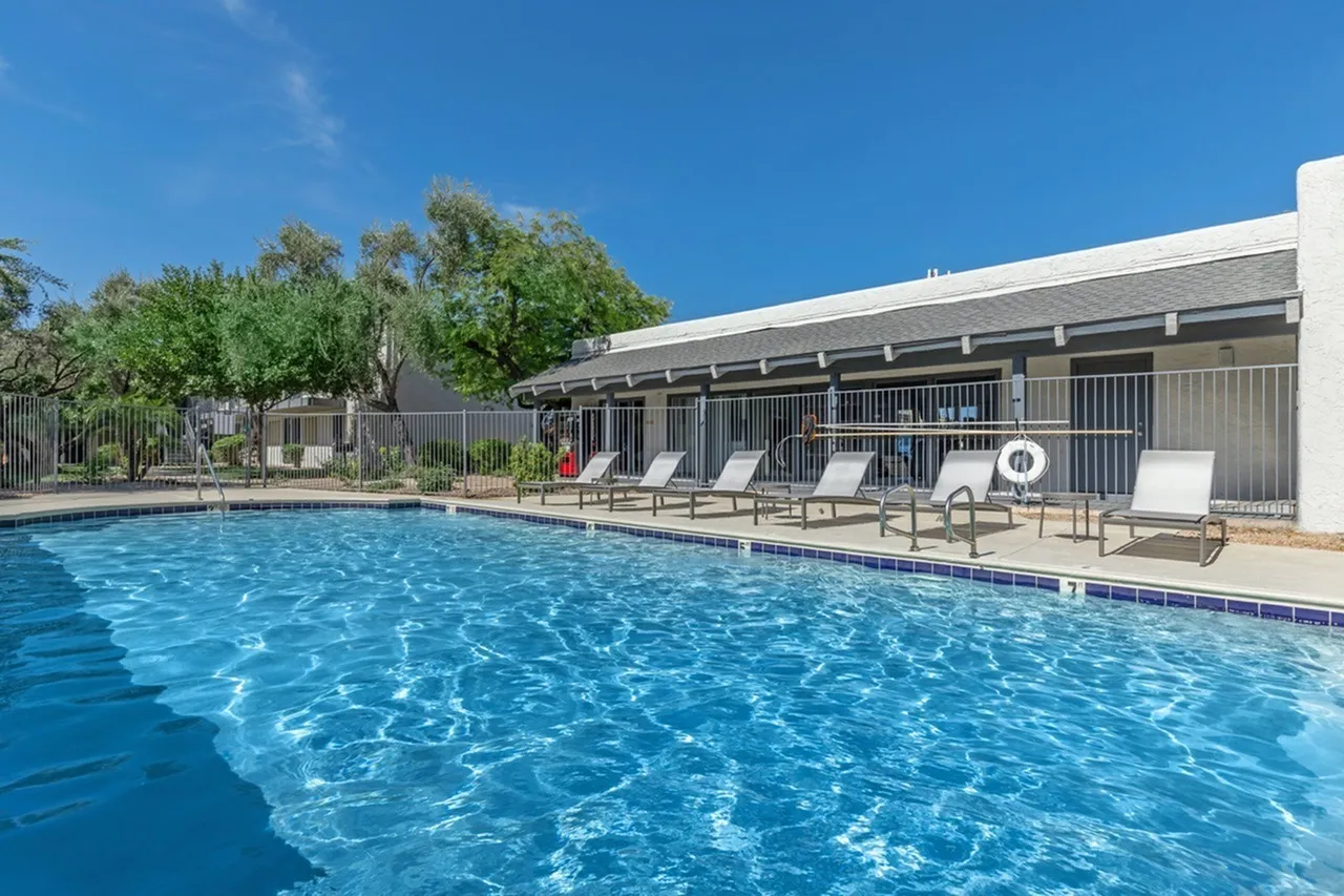 Pool with blue water, lounge chairs, covered shelter, Rise at the Preserve