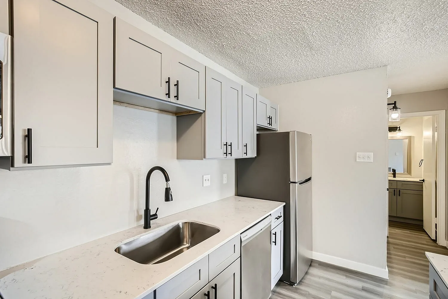 Kitchen, white shaker cabinetry, quartz countertops, stainless appliances, black hardware