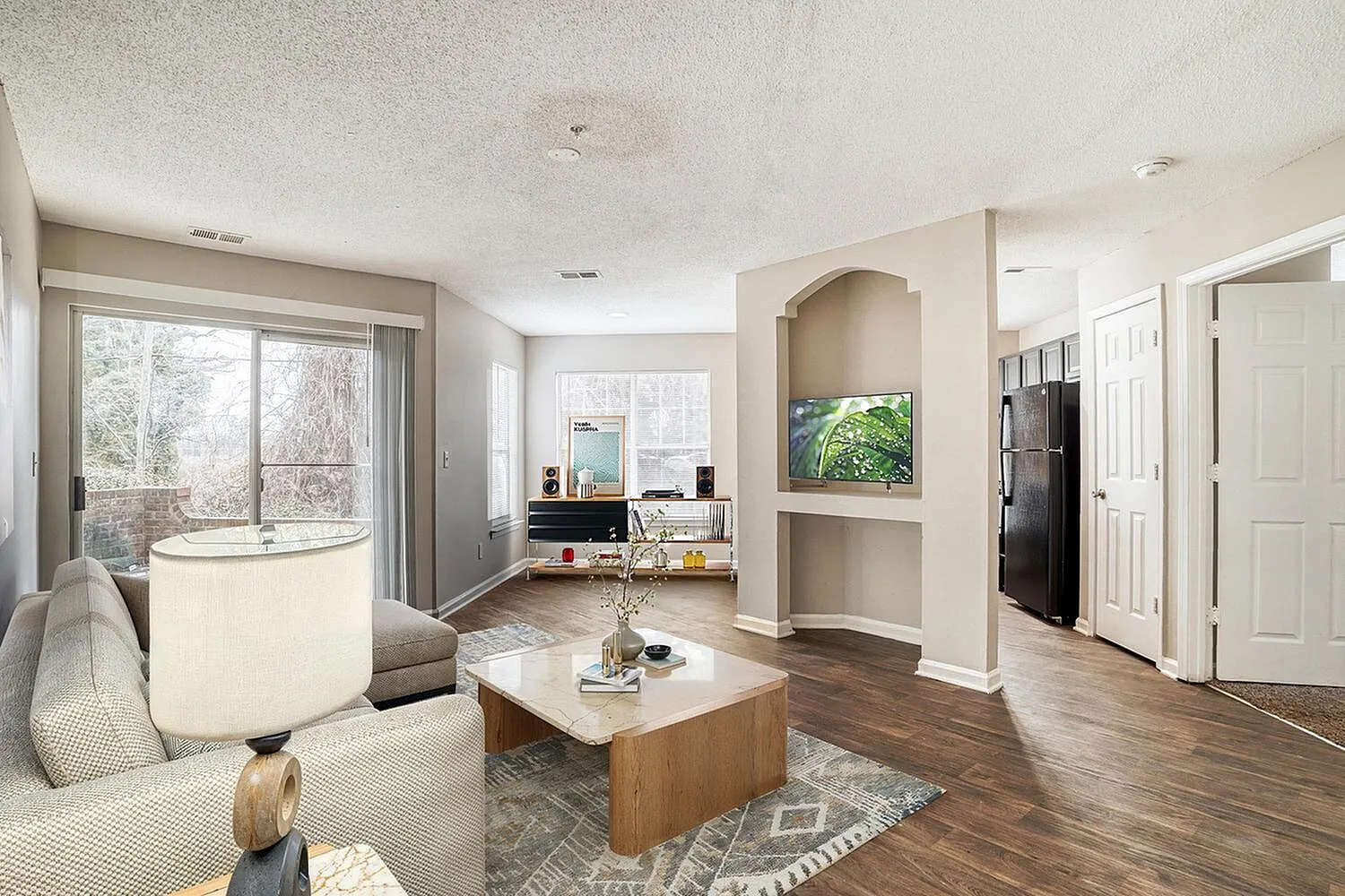Living room, wood-style plank flooring, built-in shelving, soaking tub, arched nook