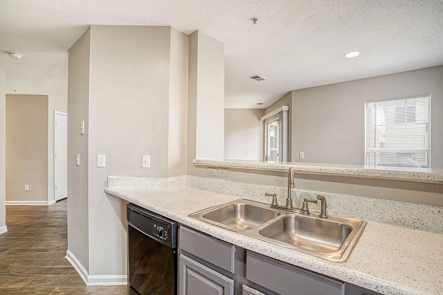Kitchen, light quartz countertops, stainless steel double sink, gray cabinetry, mirror backsplash