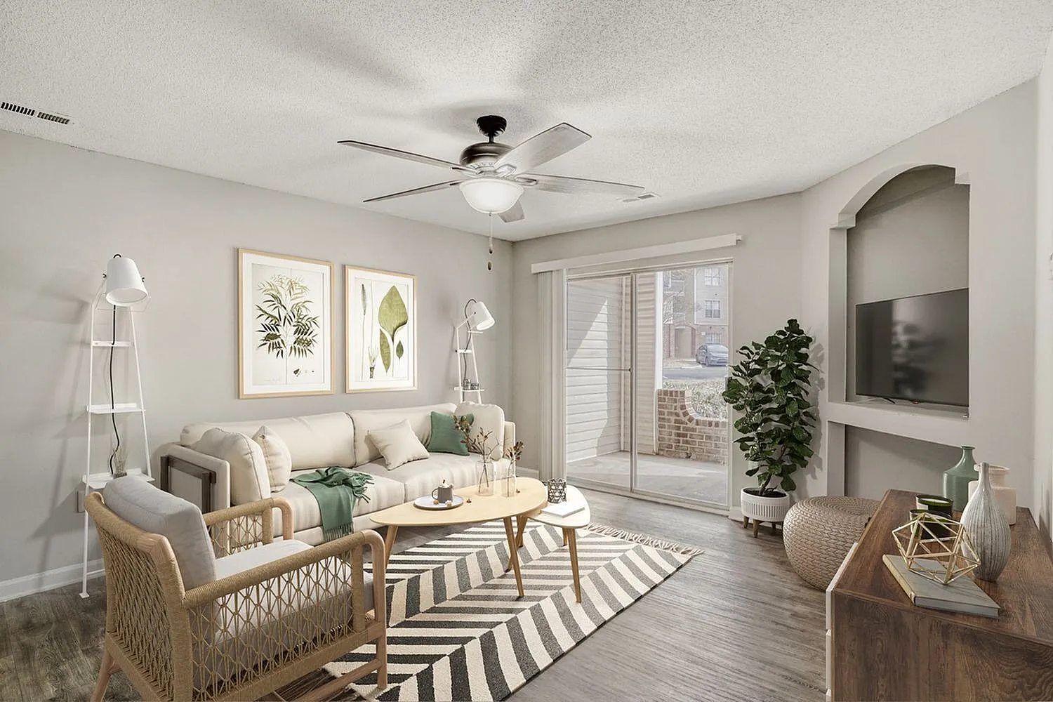 Living room, wood-style plank flooring, ceiling fan, striped area rug, upholstered seating