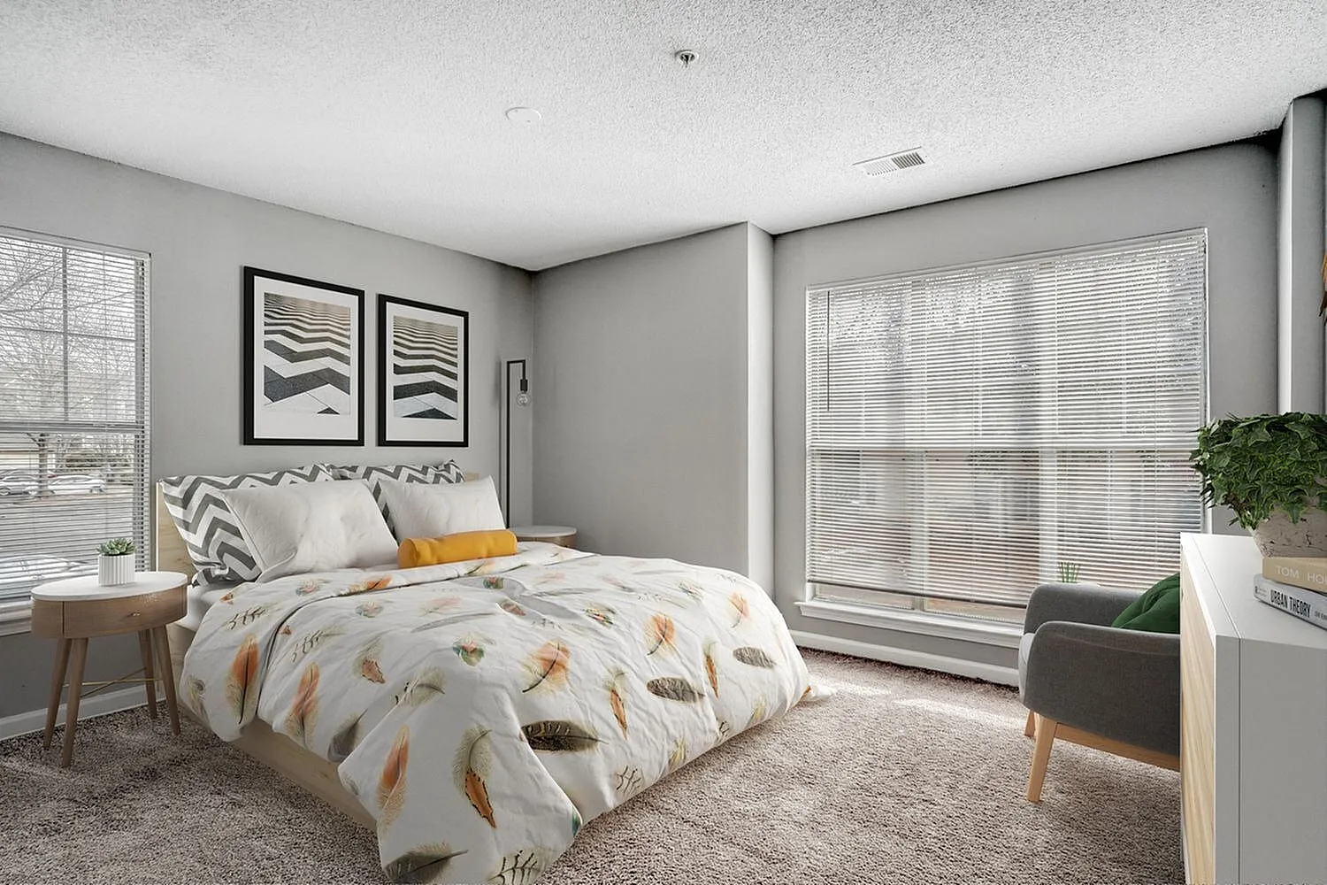 Primary bedroom, feather-print bedding, gray walls, large windows with blinds, wood nightstand