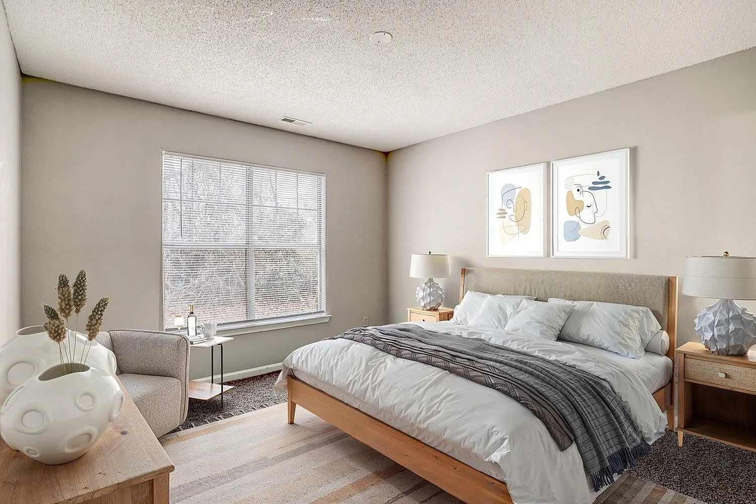 Primary bedroom, wood bed frame, white bedding, large window, wood-style plank flooring