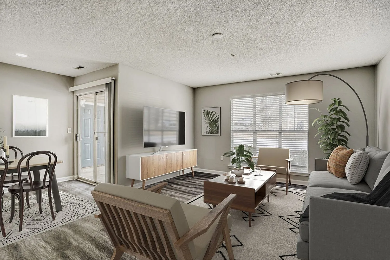 Living room, wood-style plank flooring, gray sofa, wood media console, arc floor lamp