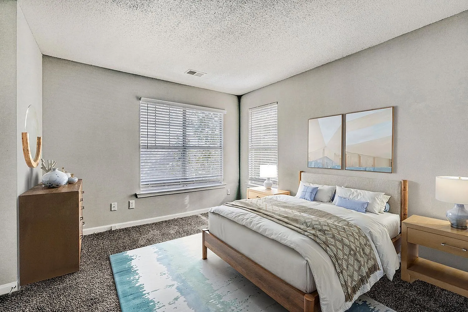 Primary bedroom, wood-style plank flooring, plantation shutters, blue area rug